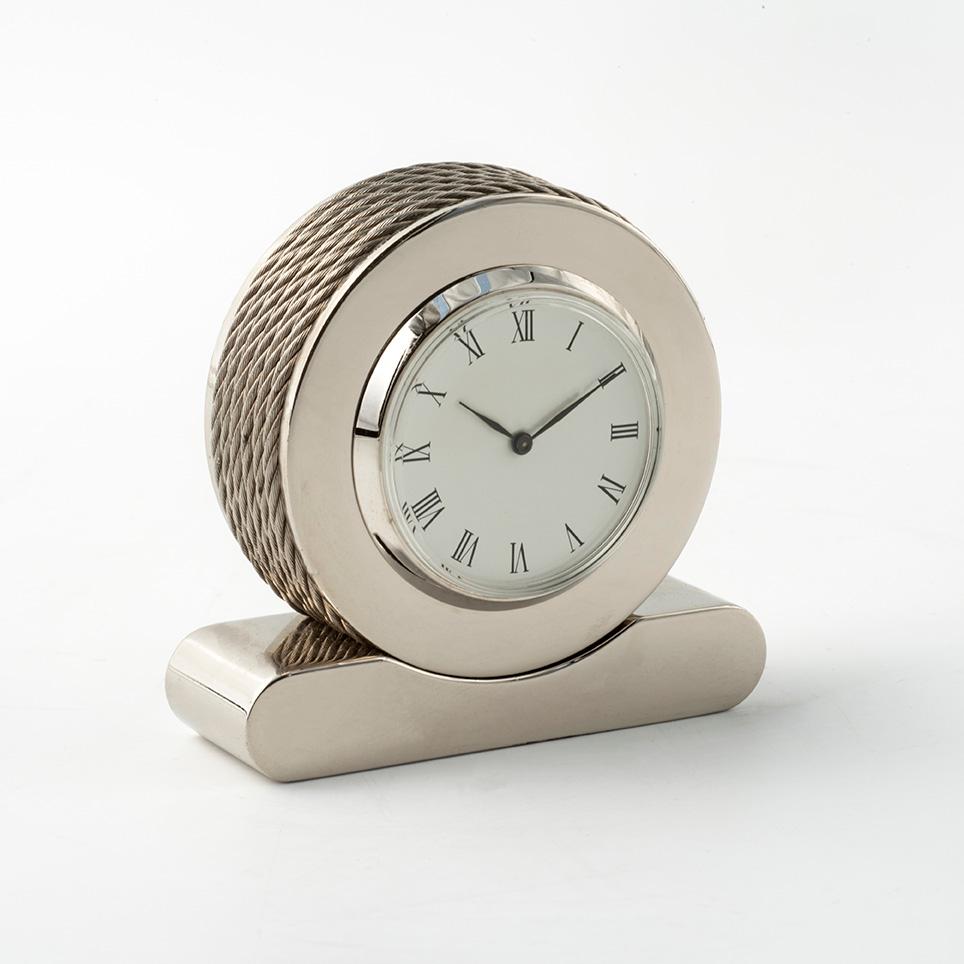MARTE è un orologino da tavolo  che abbina il design moderno  con  eleganti superfici lisce e  particolari decorativi  pescati nel mondo della nautica: 6 fili di cavetto  d'acciaio che lo avvolgono tutt'intorno. 
Un raffinato orologio ideato dal