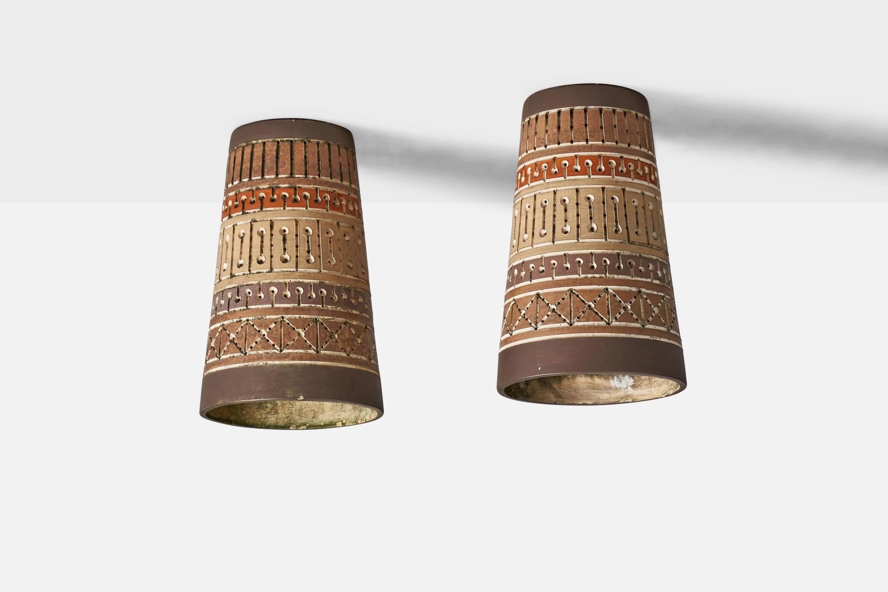 A pair of ceramic beige, brown, and orange-painted flush mounts, designed and produced by Martha and Beaumont Mood, San Antonio, Texas, USA, 1970s.

Overall Dimensions (inches): 15