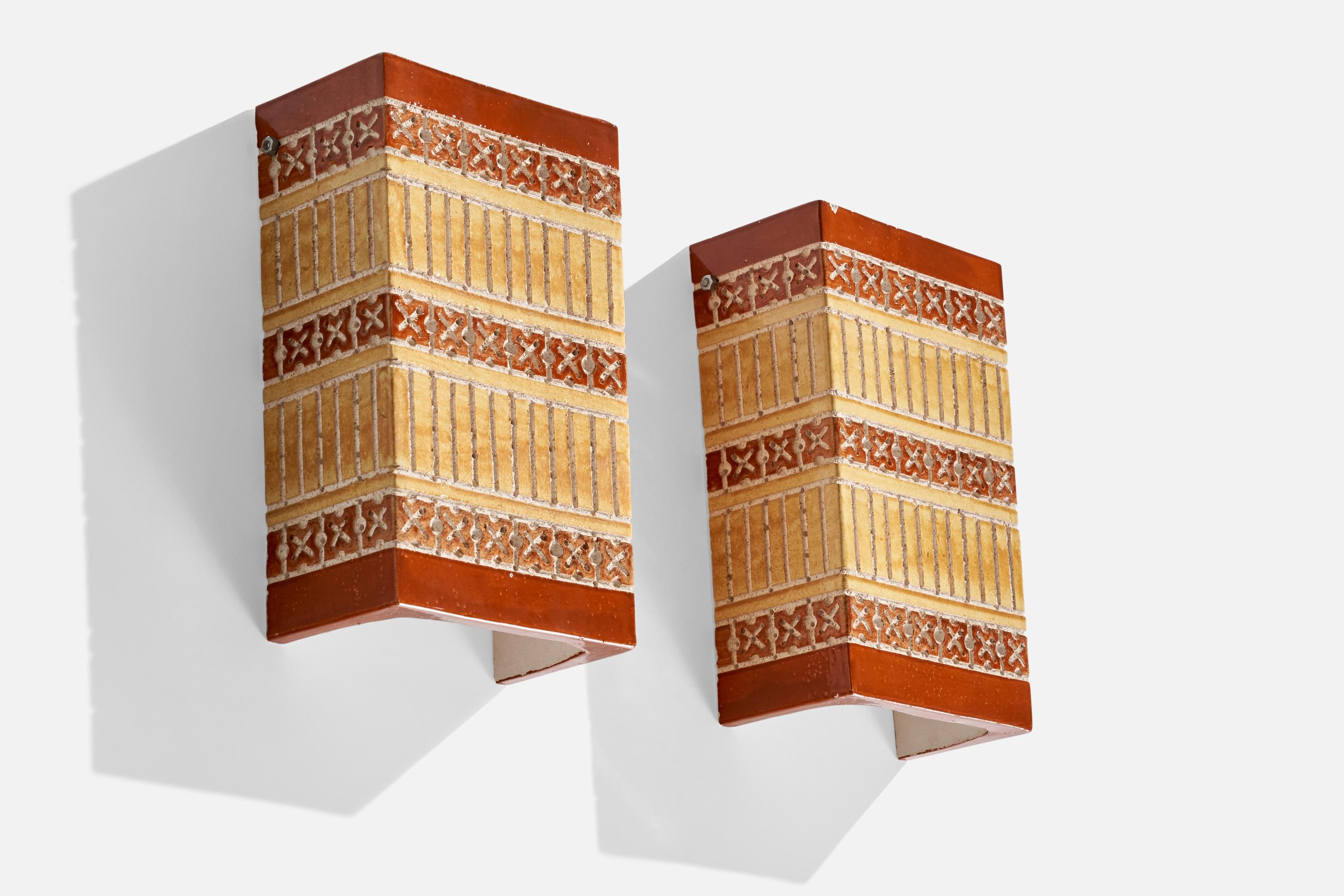 A pair of sizeable hand-painted ceramic wall lights or sconce covers designed and produced by Martha and Beaumont Mood, San Antonio, Texas, USA, 1970s.

