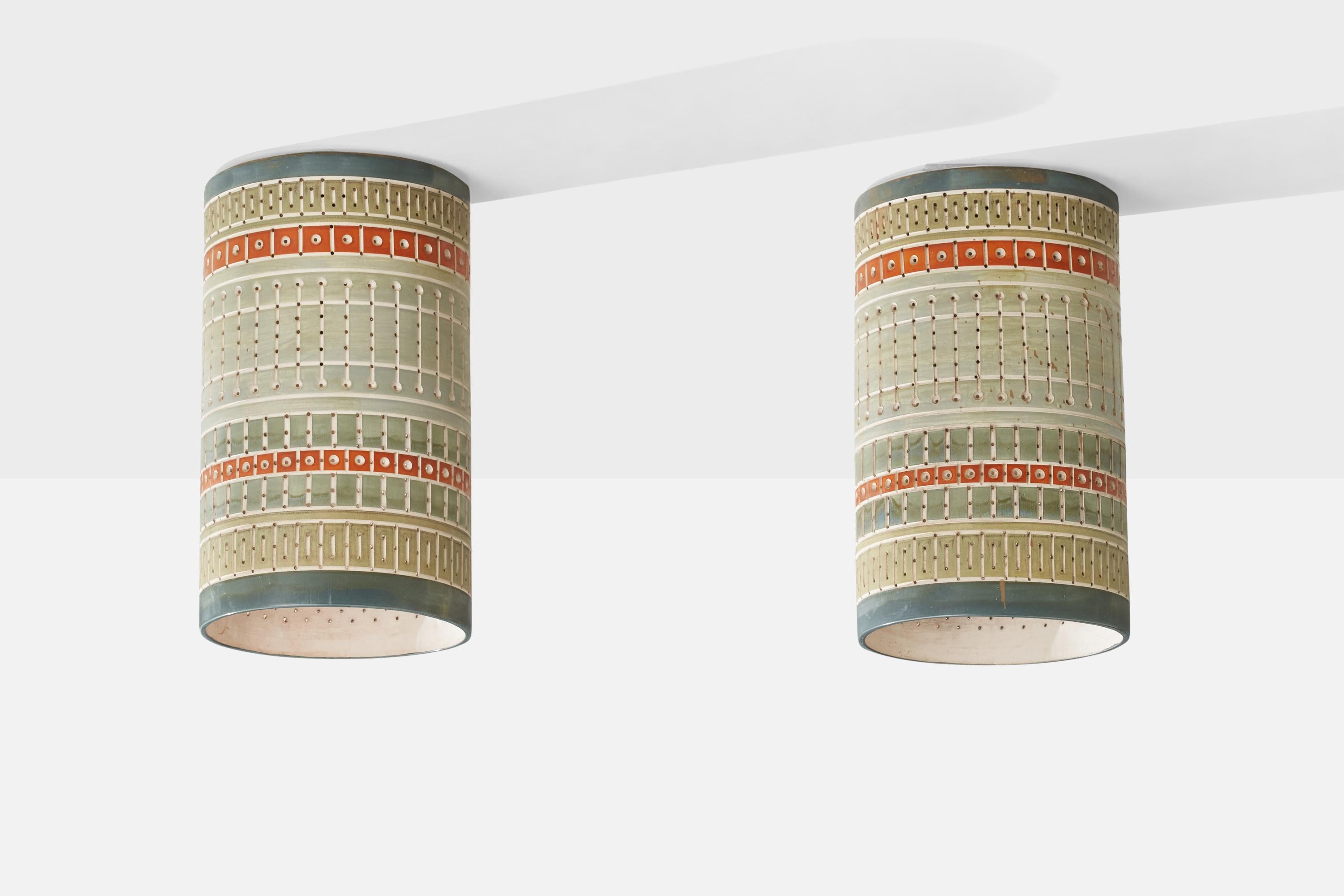 A pair of hand-painted yellow, red and green blue ceramic flush mounts or pendant lights, designed and produced by Martha & Beaumont Mood, San Antonio, Texas, USA, 1970s 

Overall Dimensions (inches): 18.25H x 10.75” D
Back Plate Dimensions
