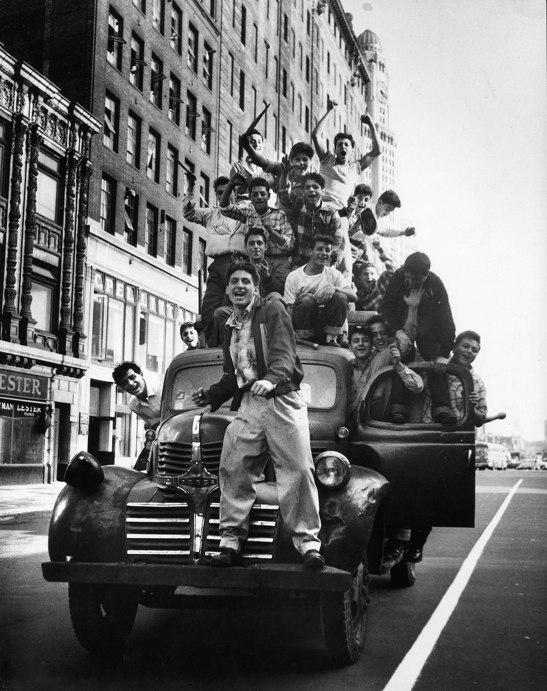 Martha Holmes Black and White Photograph - Brooklyn Dodger fans celebrating World Series victory, Flatbush Avenue, Brooklyn