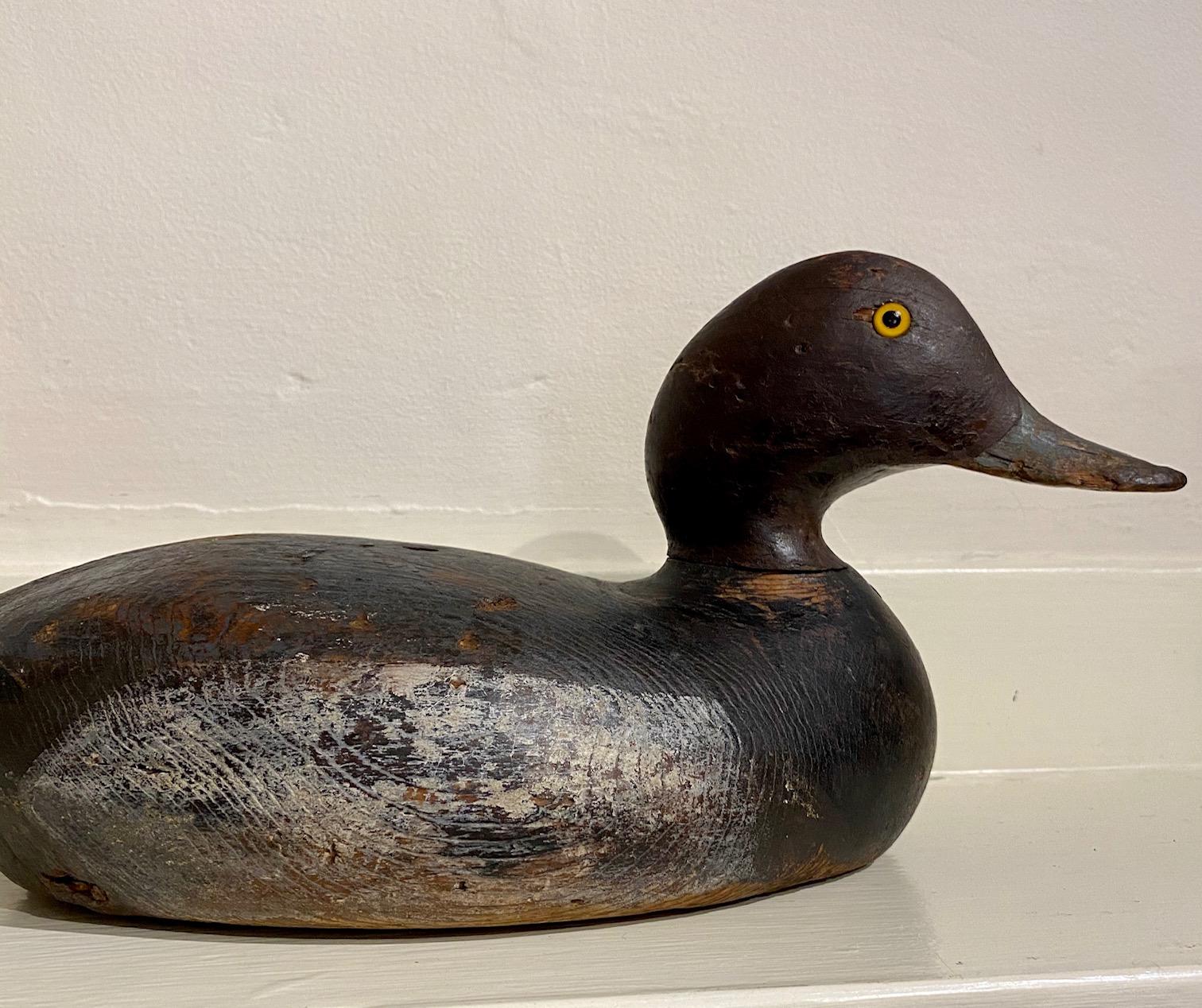 Antique Martha's Vineyard Goldeneye Hen Decoy by Frank Richardson, from Anthier's Pond in Edgartown (now called Sengekontacket Pond), circa 1910-1920, having a carved head with glass eyes, mounted on hollow carved body with 