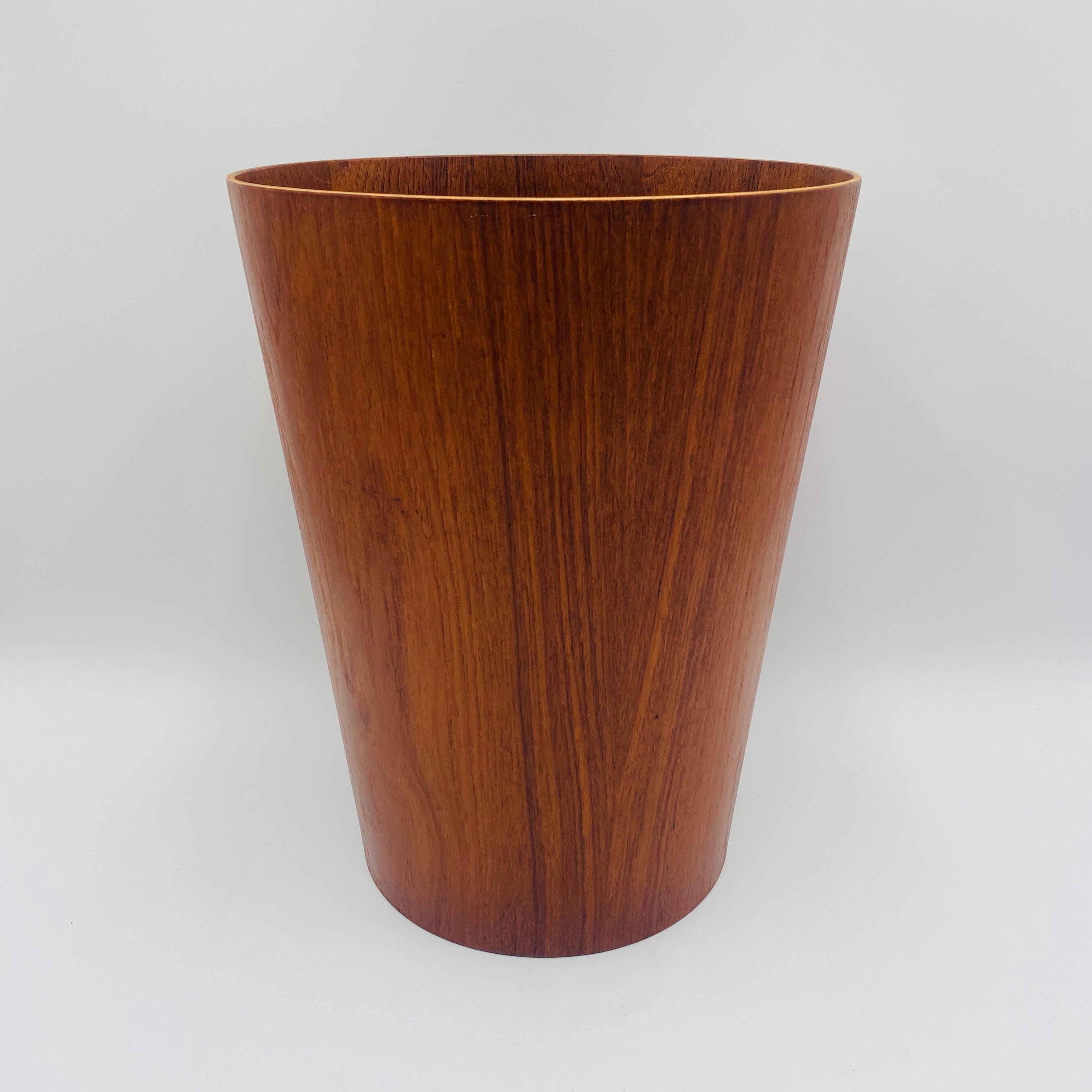 An iconic teak veneered wastebasket, designed by Martin Åberg for Servex of Sweden; marked with heat stamps underneath. 