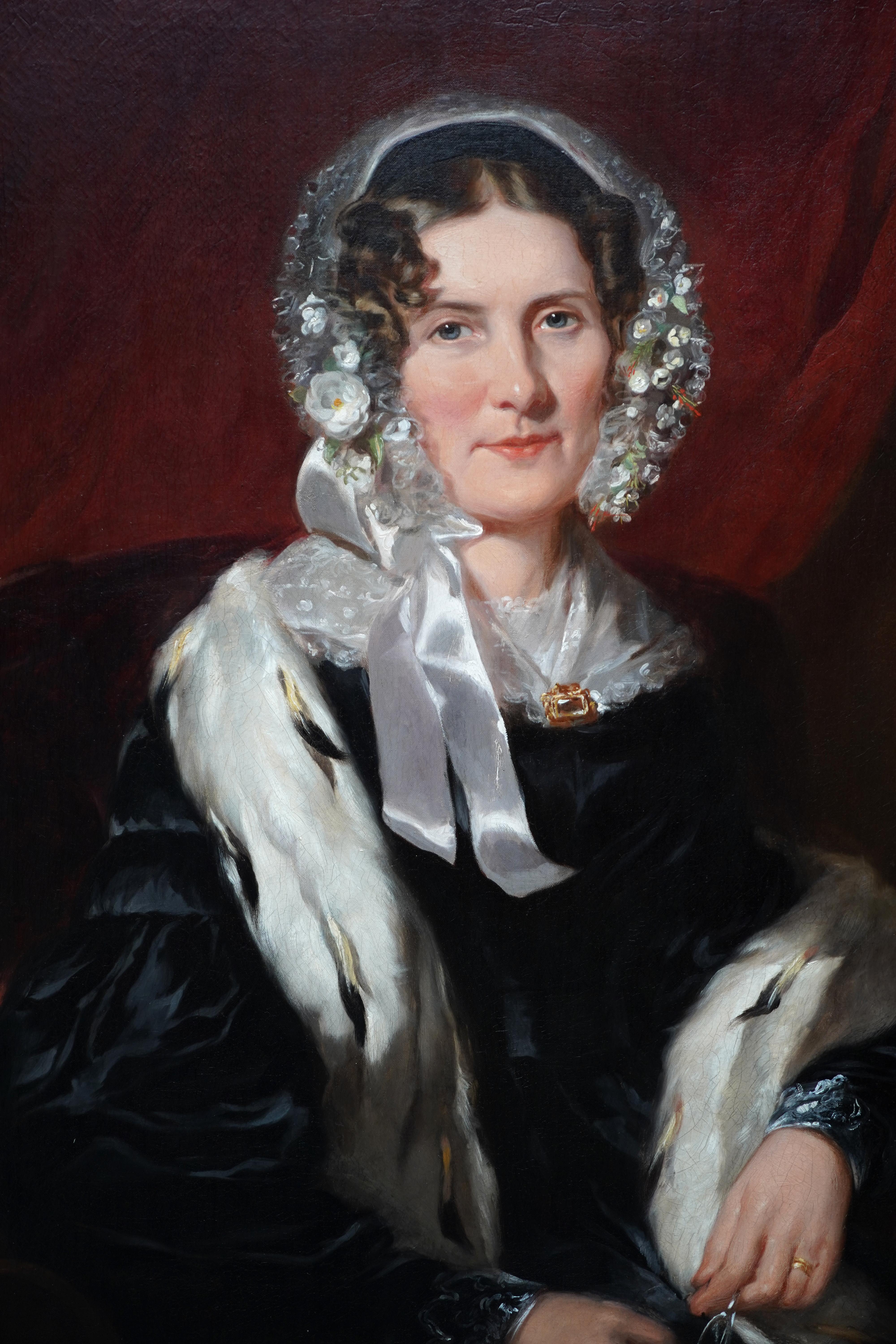 This wonderful 19th century interior portrait oil painting is attributed to the circle of Martin Archer Shee. It is a half-length portrait of a seated lady in a black silk dress, ermine stole and superb floral bonnet. It is a super realistic