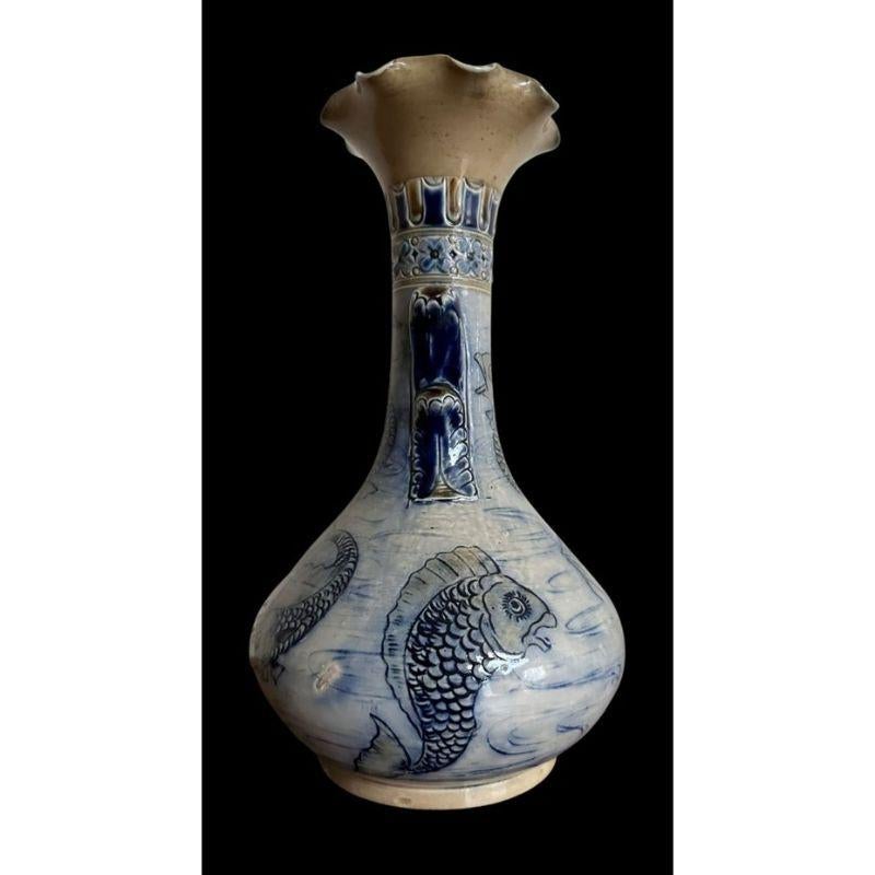 Early Martin Brothers Aquatic vase decorated with numerous fish with seaweed lug handles

Small, invisible restoration to the rim - several firing irregularities to one area

Dimensions: 26cm high, 14cm wide

Dated 1874

Complimentary