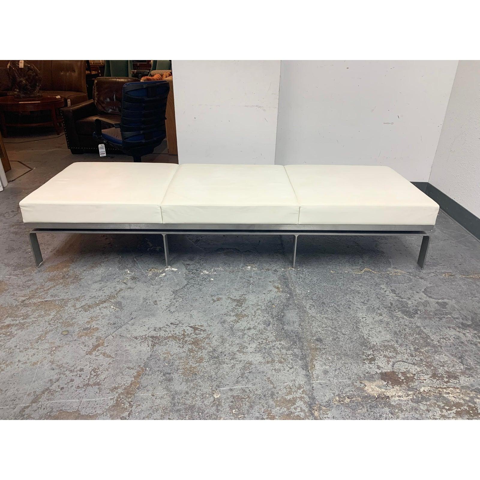 Presents a Martin Brattrud custom one leather bench. Designed by Collin Burry and Terry Walker the daybed is a fusion of formal precision and functional flexibility. Three equal parts firmly rest on a narrow solid steel platform in an open and airy