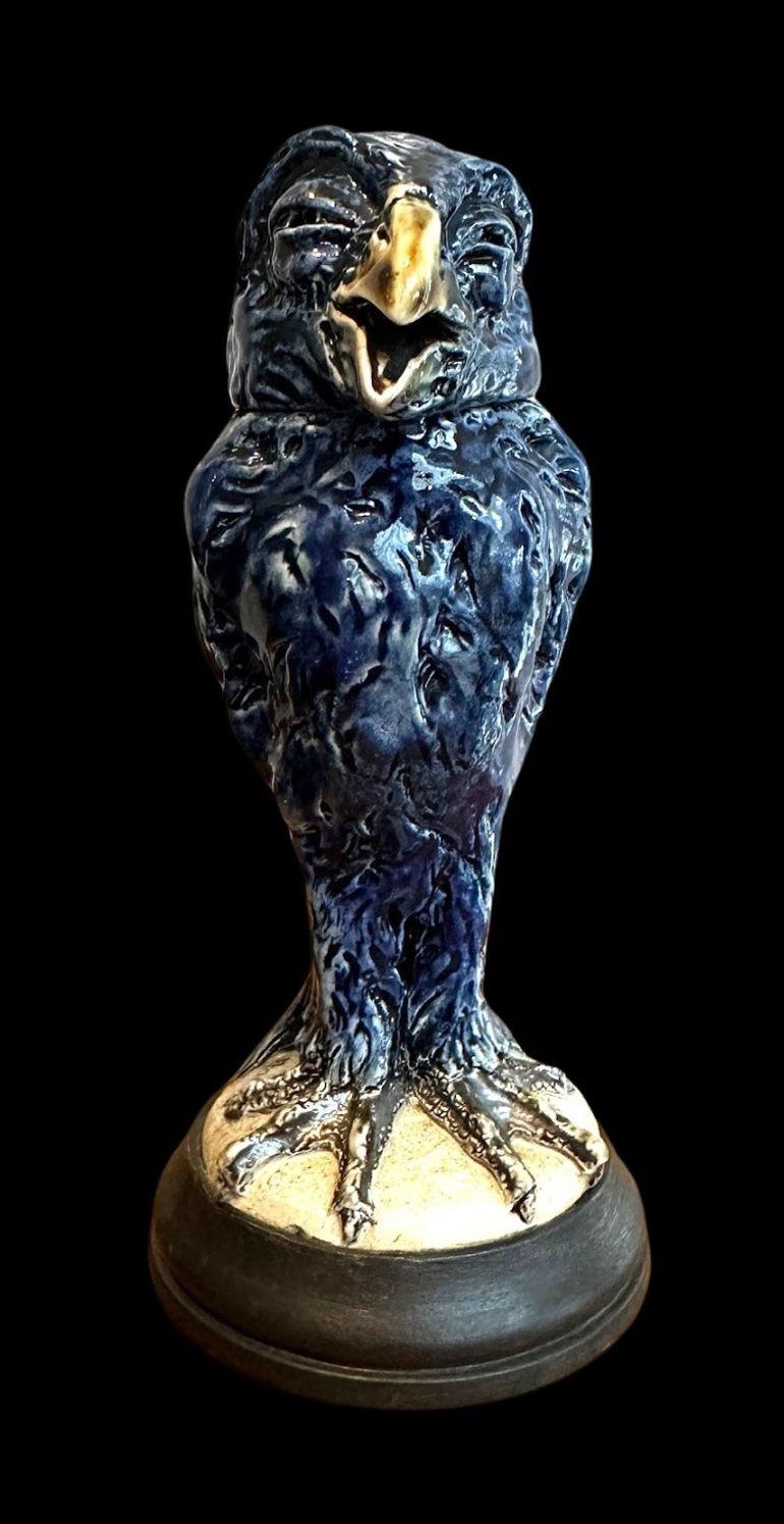 5466
Robert Wallace Martin for the Martin Brothers.
A charming Bird sculpture in a Cobalt Blue Glaze with wings tucked to the rear, open beak and a quizzical, curious expression
17.5cm high
Dated 1913