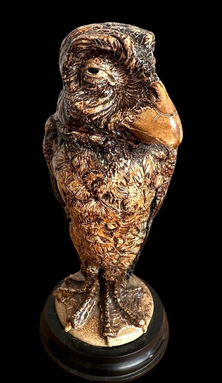 16
R W Martin for the Martin Brothers a Bird Sculpture with webbed feet and raised eyebrow.
This is a well modelled example and dated 1903
There is rubbing tothe glaze to the back of the head and a small glaze chip to the front of the head under the