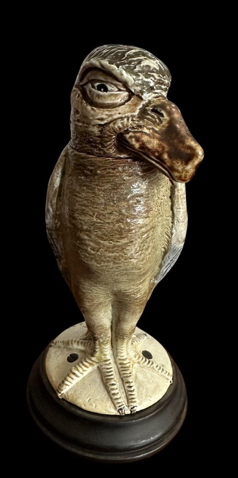 185
Martin Brother's Bird with a portly tummy and stubby beak in shades of light tan, green and blue
Small graze to the glaze to the rear of head and restration accross the legs
The flange has a leather colar, that likely conceals the date but Circa
