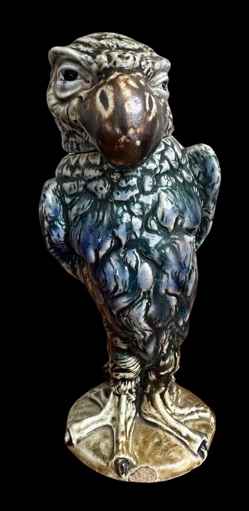 188
Martin Brothers Bird with Jaunty expression decorated with Cobalt, Buff, Brown and Turquoise Glazes.
22.5cm high, 9cm wide, 8cm deep.
Marked to the base and head, R.W. Martin & Bros, Southall.
It is unlikely this Bird has had a wooden base, but