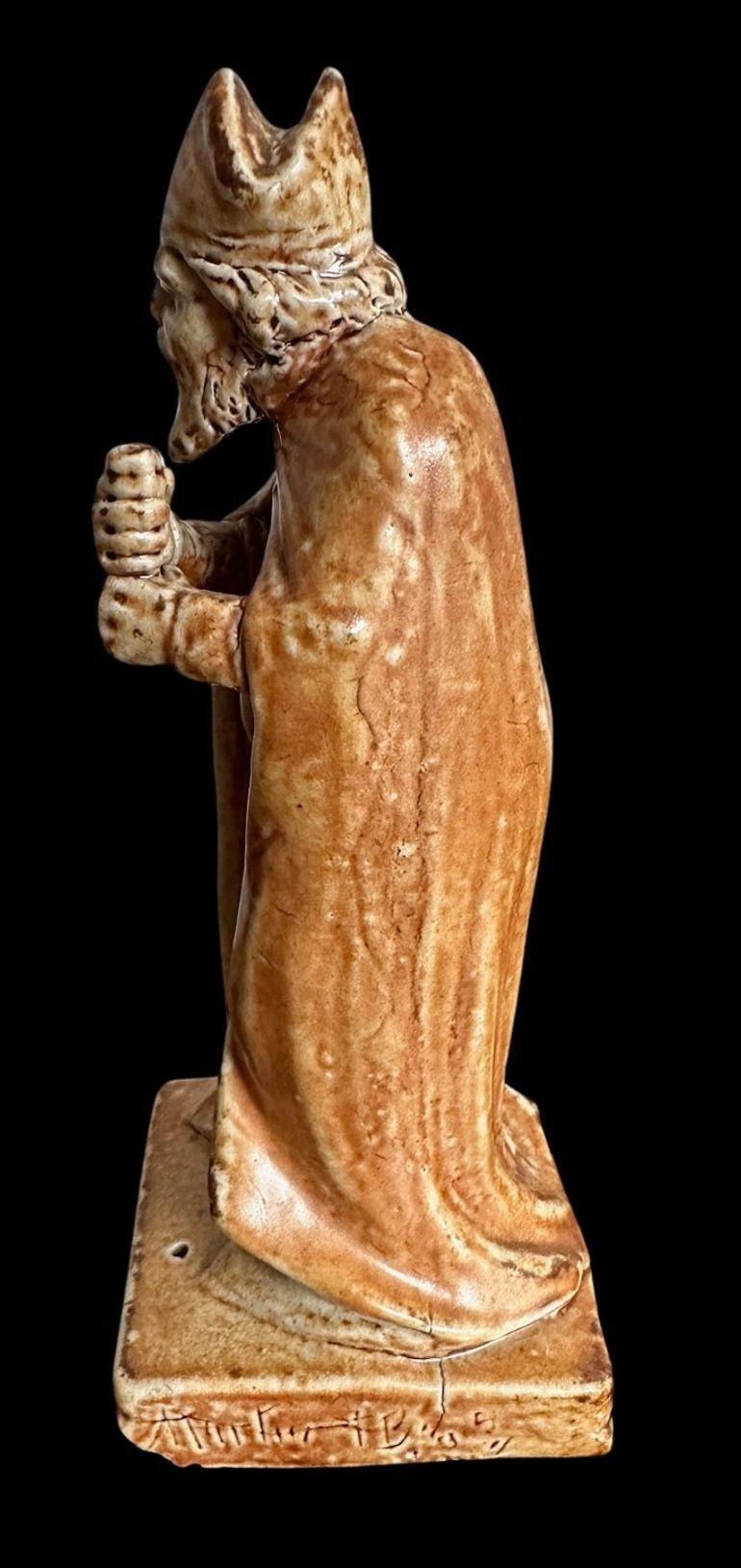 22
R W Martin for the Martin Brothers, a Chess Piece modelled as a Bishop
Lacking Staff and large chip to the plinth, several firing cracks
17cm high, 6.5cm wide, 6.5cm deep
Dated 1901