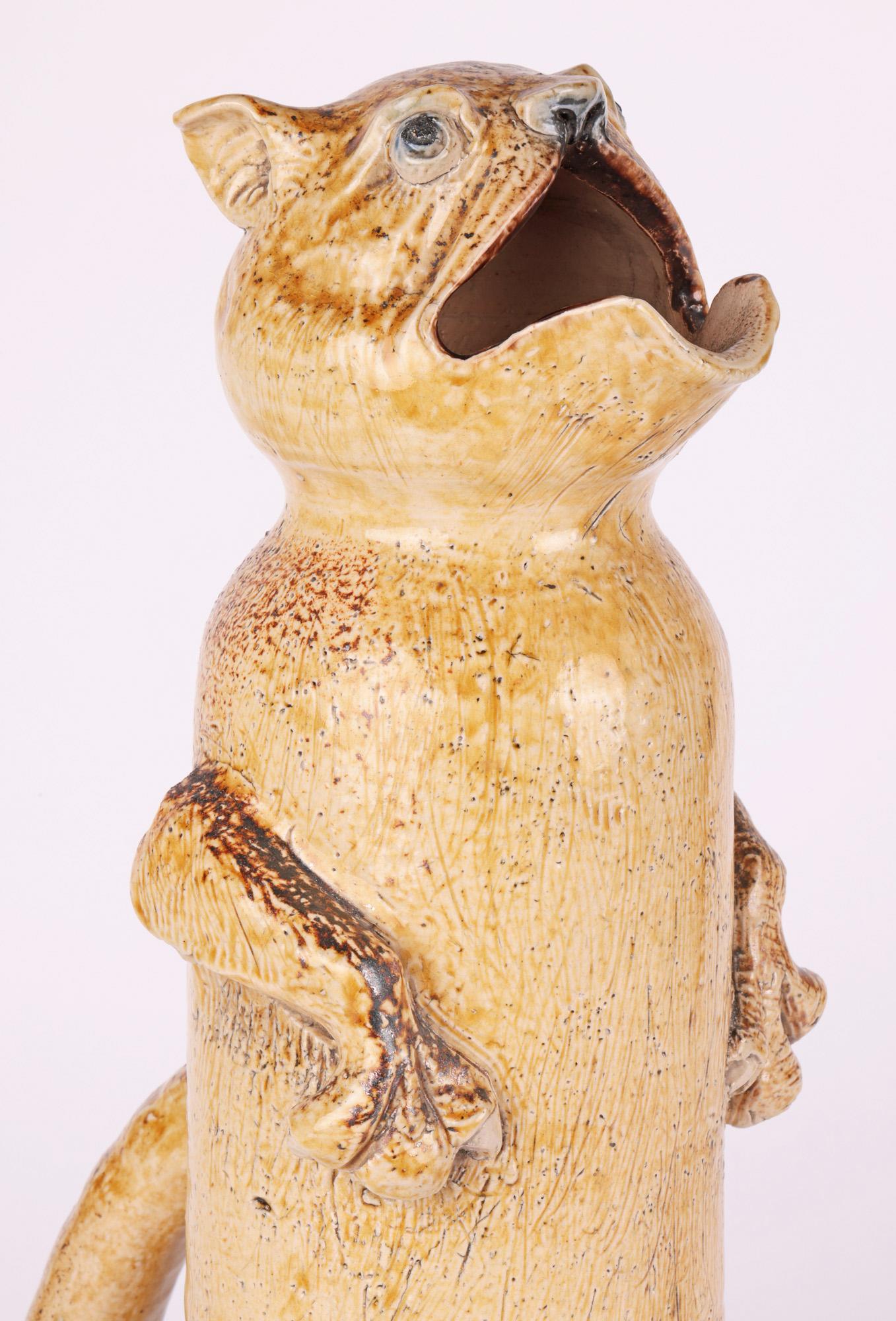 A rare, probably unique, tall grotesque figural ewer by Robert Wallace Martin for the Martin Brothers dated 1880. The ewer is very tall and modelled as a fanciful animal seated upright on its hind legs and with its front paws by its side. The ewer