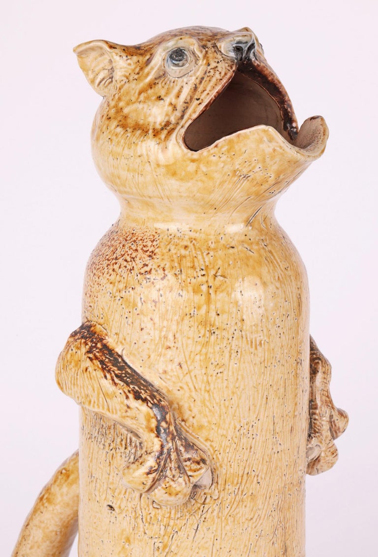 A rare, probably unique, tall grotesque figural ewer by Robert Wallace Martin for the Martin Brothers dated 1880. The ewer is very tall and modelled as a fanciful animal seated upright on its hind legs and with its front paws by its side. The ewer
