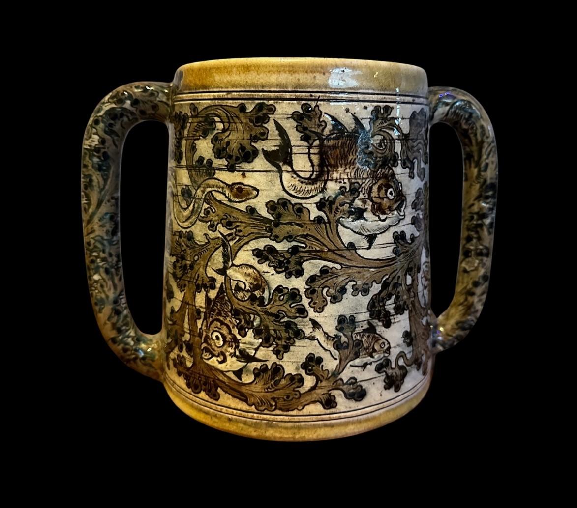5461

Martin Brothers Loving Cup with a crisp firing of an aquatic scene with twin handles.

The vessel, thrown and decorated by Edwin and Walter Martin features stylised decoration of 9 fish and an Eel against scrolling seaweed.

Formerly exhibited