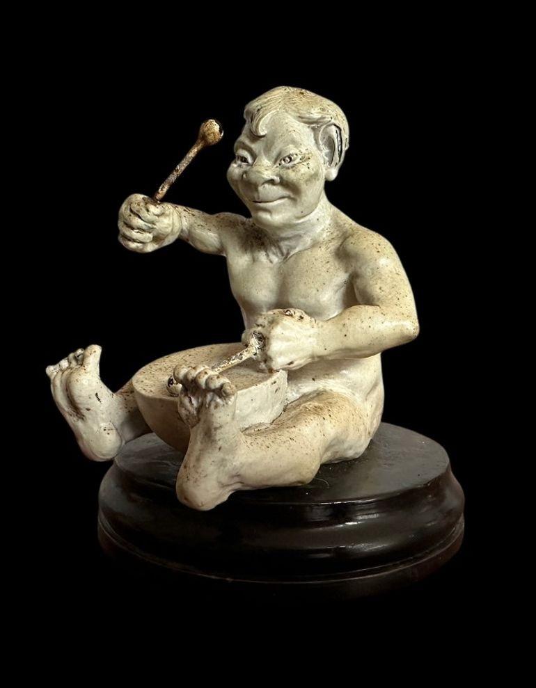 2
R W Martin for the Martin Brothers, a Musical Imp Playing the Drums
This scarce example is all the rarer to have its drum sticks intact - losses of paint to the sticks
The imp is loose on its ebonised stand and has some filler under his left toes
