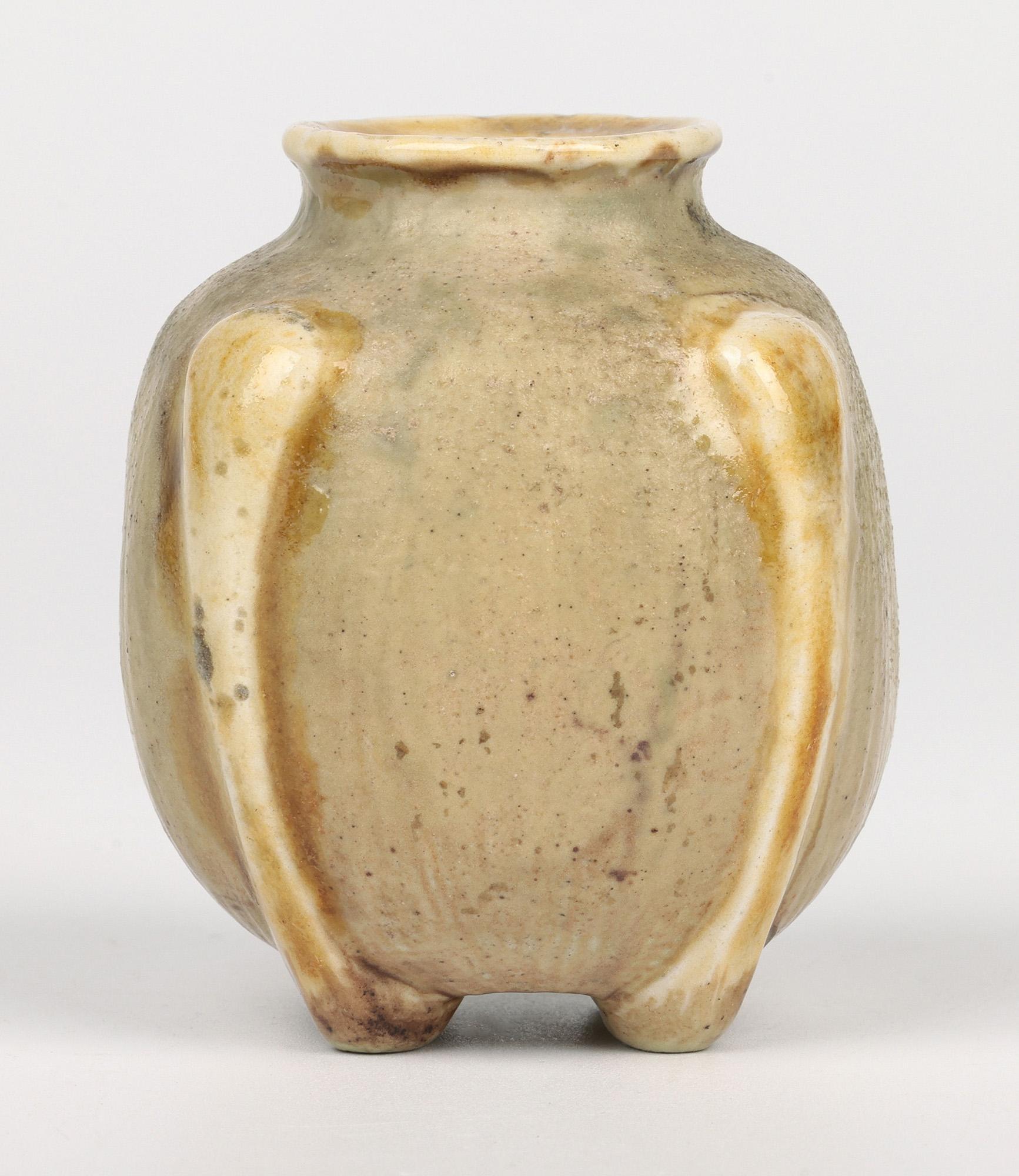 A stunning and a real favorite is this finely made gourd shaped art pottery vase by Martin Brothers, Southall, London and dated 1901. The small stoneware vase is of square form standing raised on four feet which extend up the body and form four