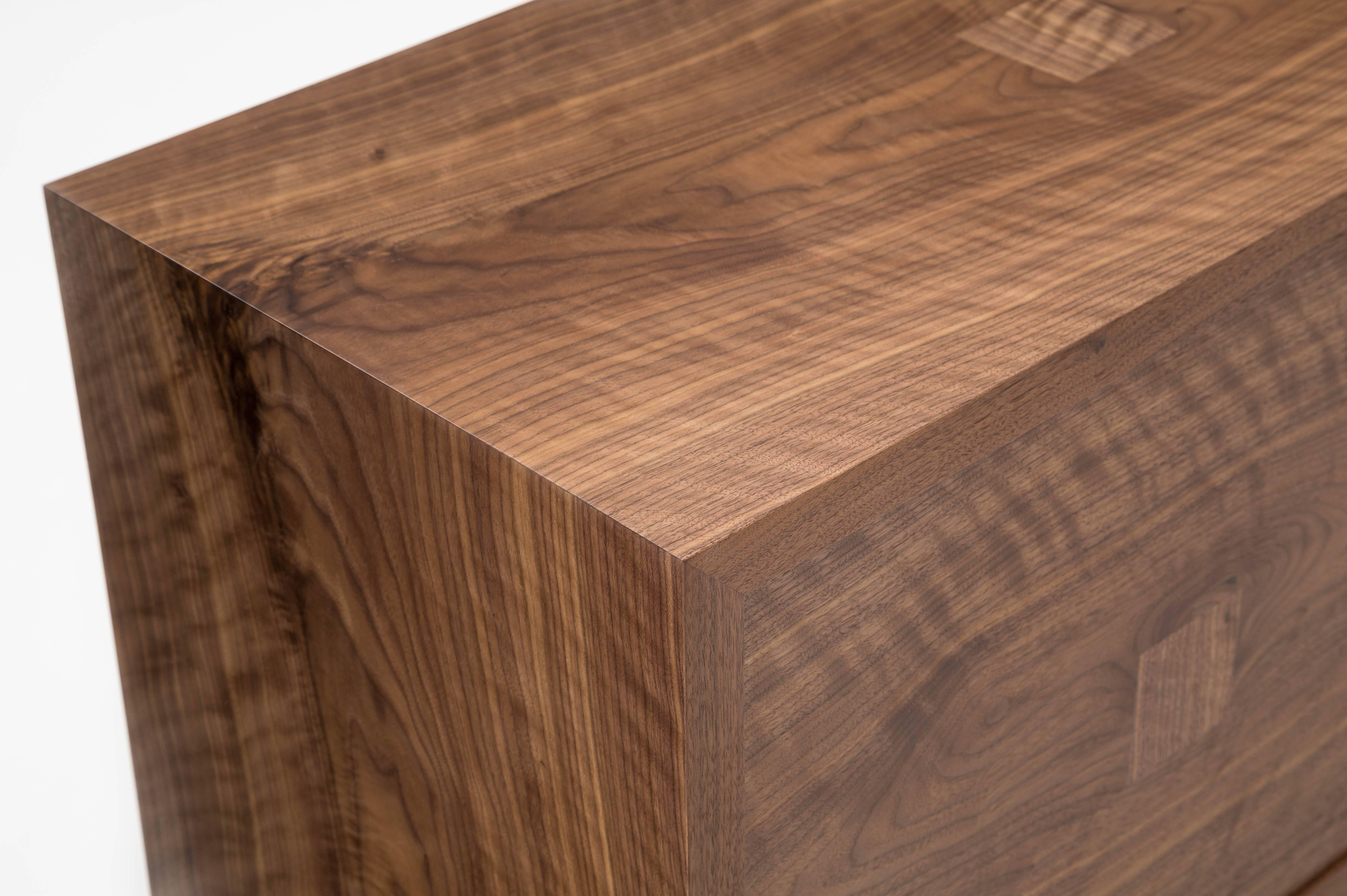 The Marvin credenza is built in our Brooklyn studio using premium hardwoods and thoughtfully selected wood veneers. The cabinet showcases wide, featured American walnut, with book-matched front doors and waterfall edges. The door pulls are custom