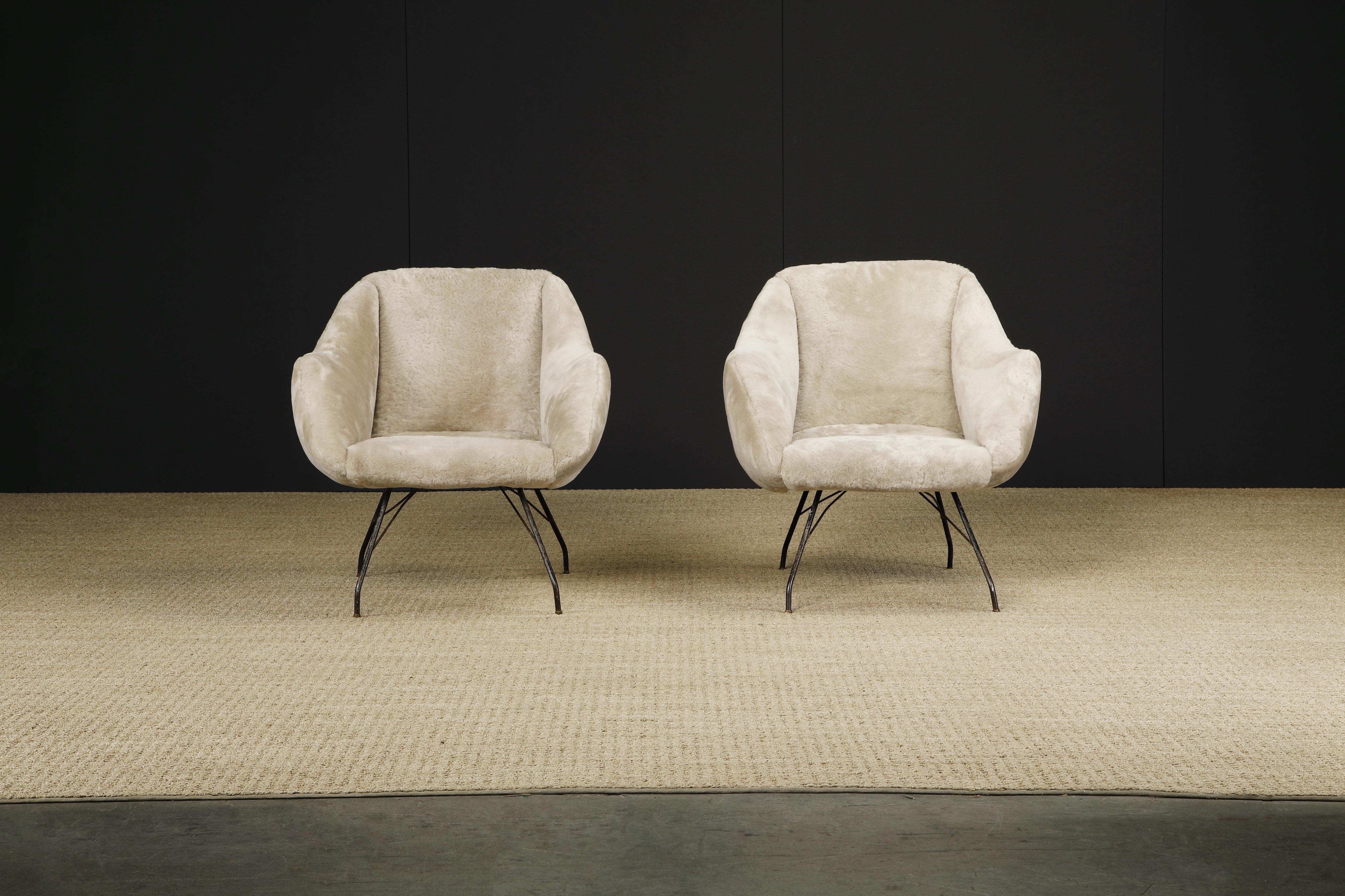 Beautifully reupholstered with soft furry taupe colored sheepskin, this pair of 'Concha' chairs by Martin Eisler and Carlo Hauner for Forma, Brazil, encapsulates the quality and innovation of their designs. This elegant scoop chair with its slightly