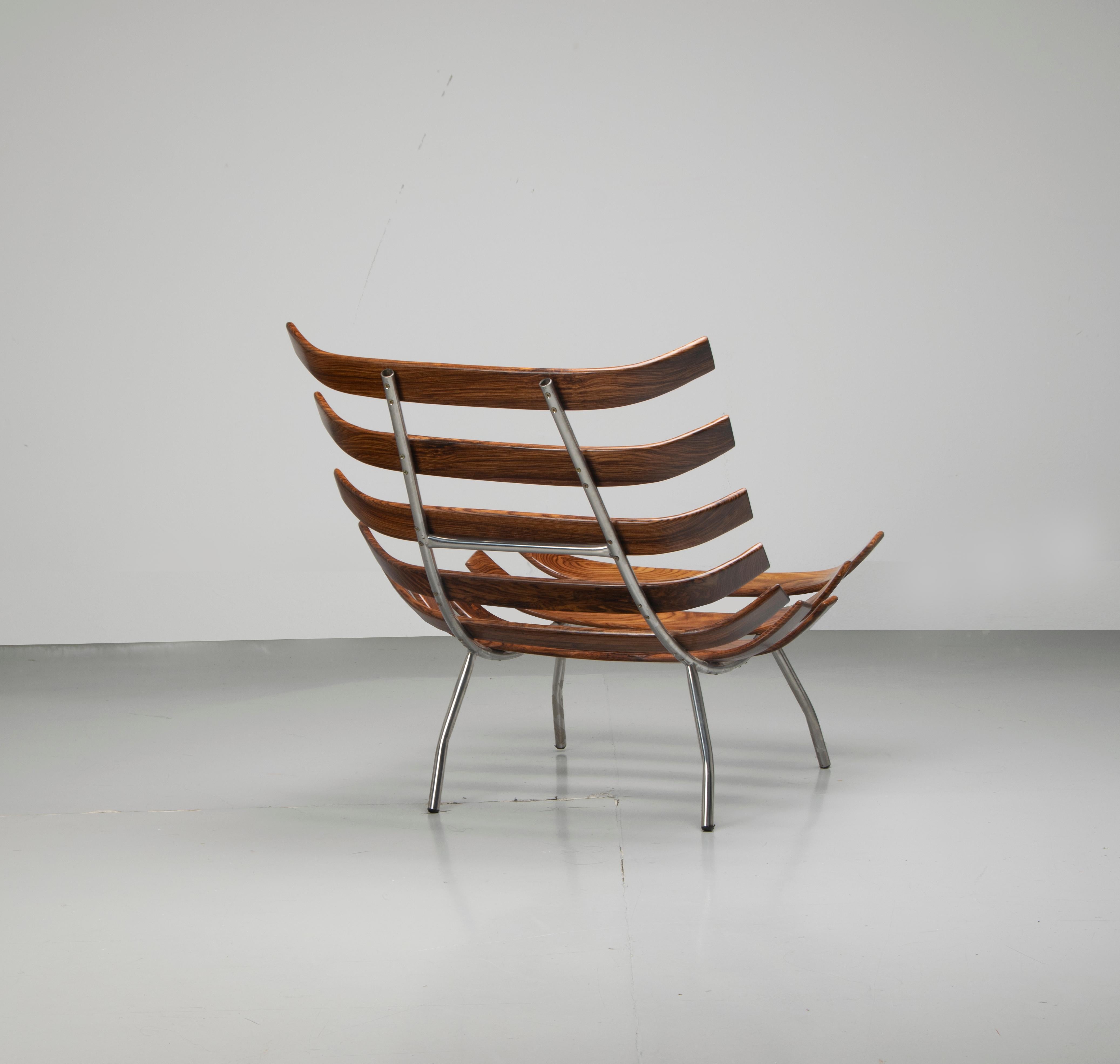 Rib chair (also called Costela chair) designed by Martin Eisler and Carlo Hauner in Brazilian Caviuna wood and metal. These chairs are iconic Brazilian Mid-Century Modern pieces, circa 1960. The chair has been recently reupholstered in off-white