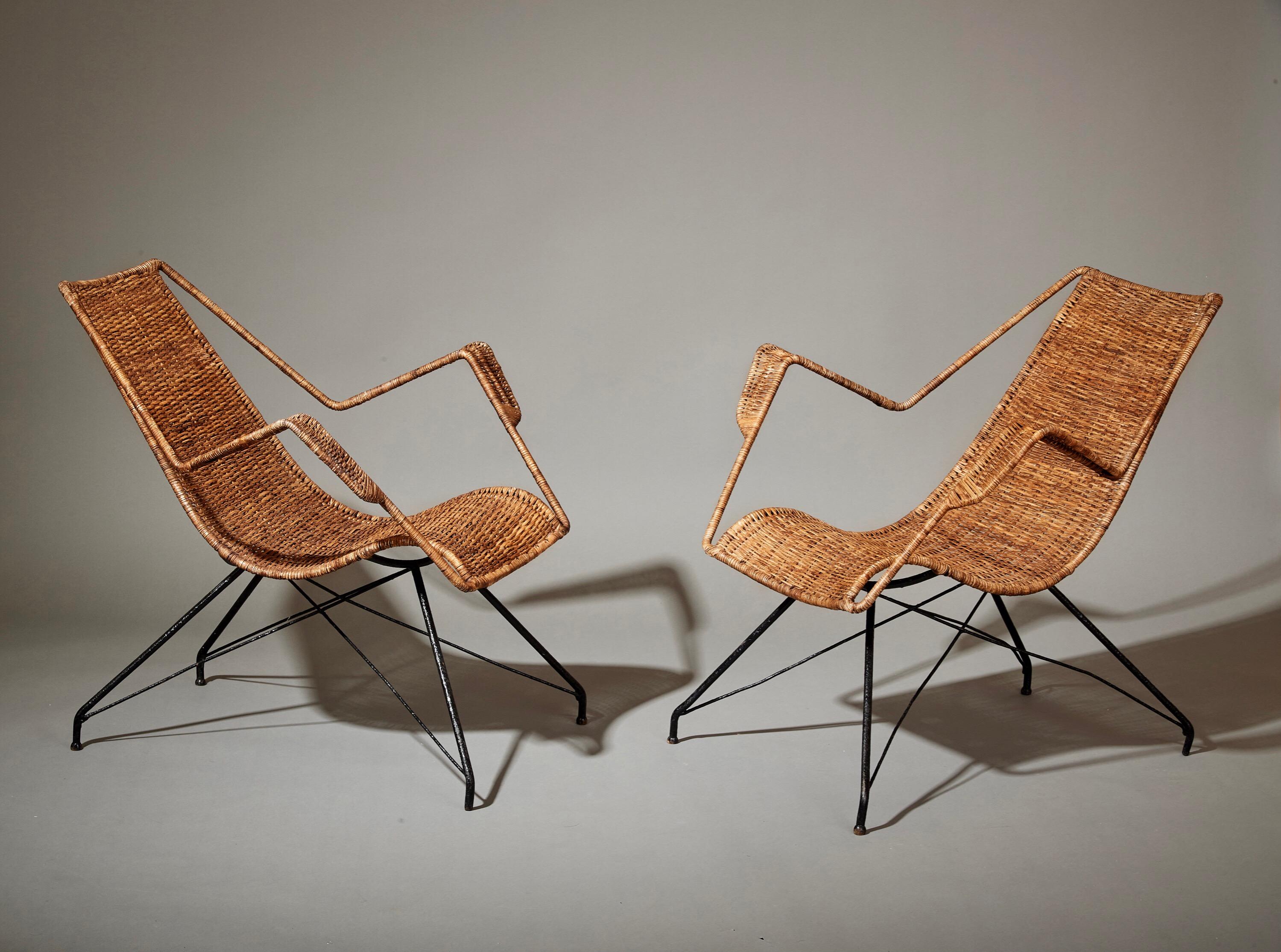 Martin Eisler (1913-1977) and Carlo Hauner (1927-1997) 

A rare and exceptional pair of lounge chairs by Carlo Hauner and Martin Eisler for their pioneering Brazilian design company, Forma. In wicker with stepped arms and enameled steel Eiffel legs.