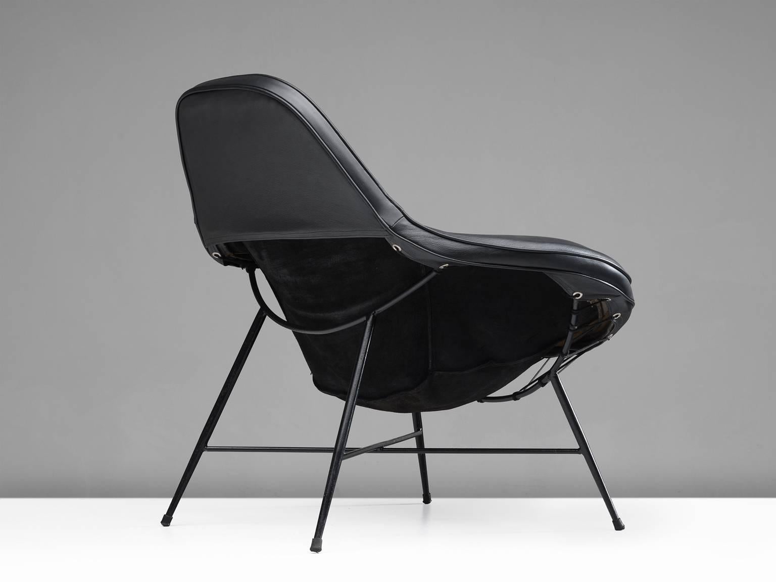 Martin Eisler, armchair, iron, upholstery, cushion and leather, Brazil, 1950.

This wide inviting armchair with thin black iron frame is designed by Martin Eisler. The seat of the chair is inviting, organic and comfortable. This shape is very