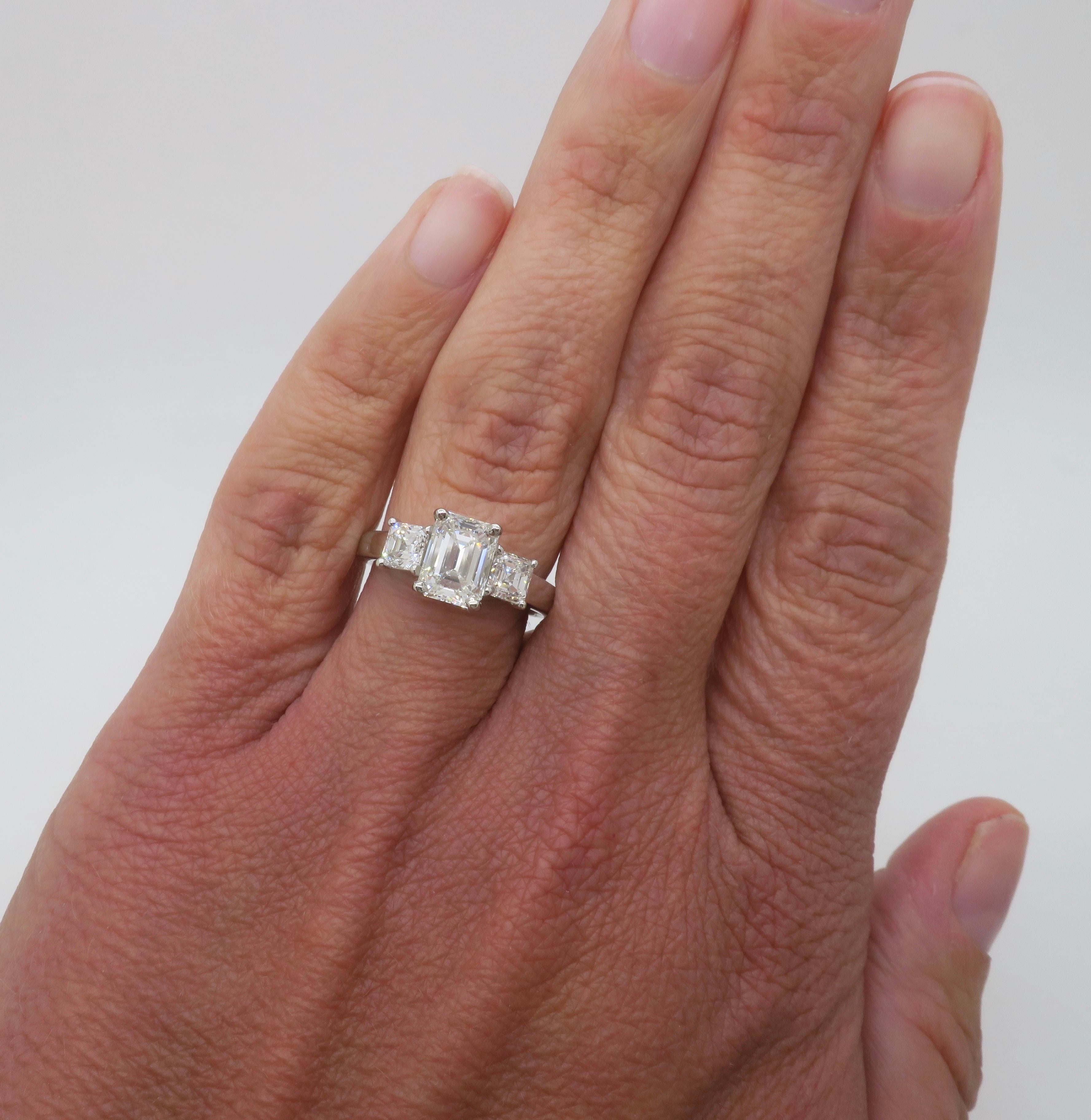 Martin Flyer three stone Diamond ring crafted in Platinum, with 2.21CTW of Earth Mined Diamonds. 

Center Diamond Carat Weight: 1.41ct Earth Mined
Center Diamond Cut: Emerald Cut 
Center Diamond Color: G
Center Diamond Clarity: VS2
Certification: