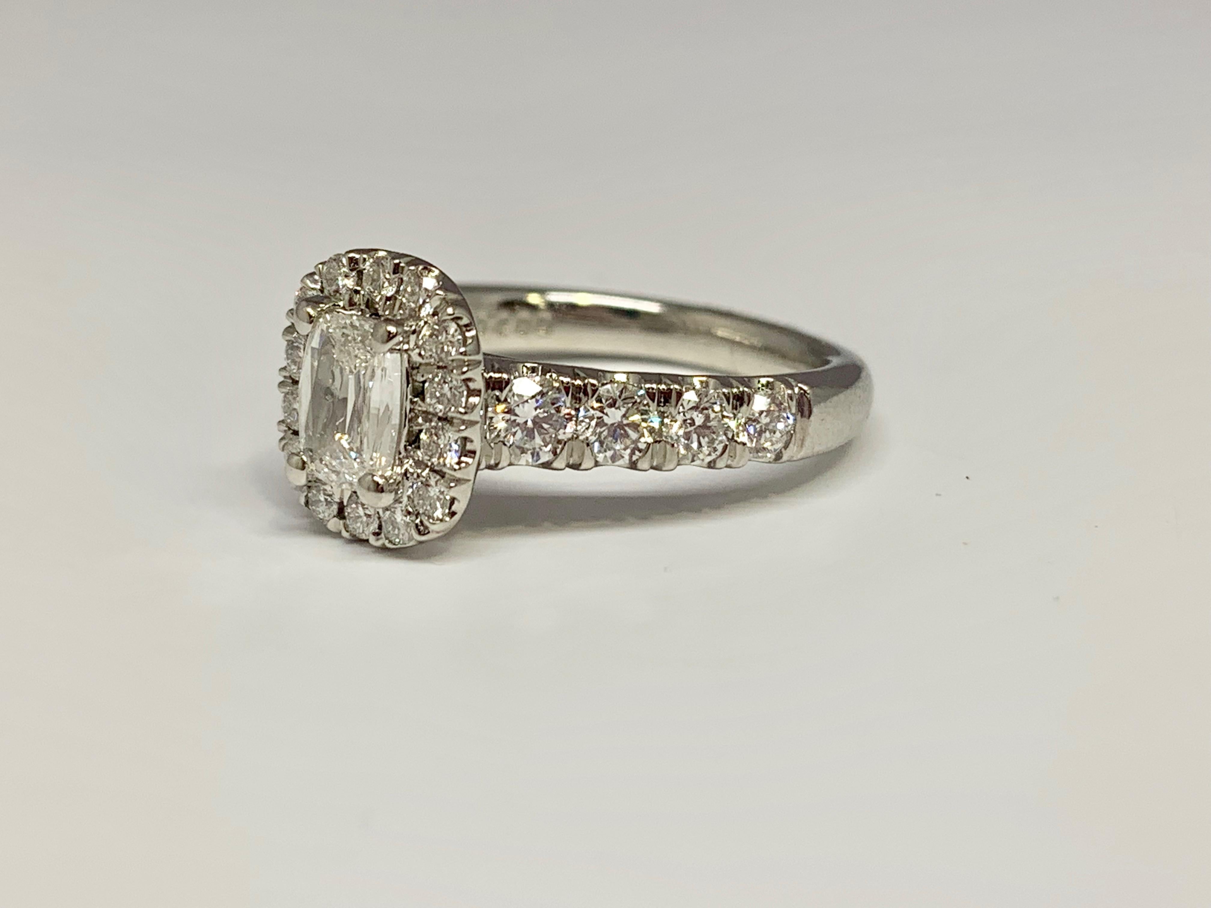 This beautiful Martin Flyer engagement ring features a GIA certified promise cut 0.47 carat center diamond. The center diamond has a color grade of E and a clarity grade of VS2. Its platinum mounting holds 0.98 carats of round diamonds on the band