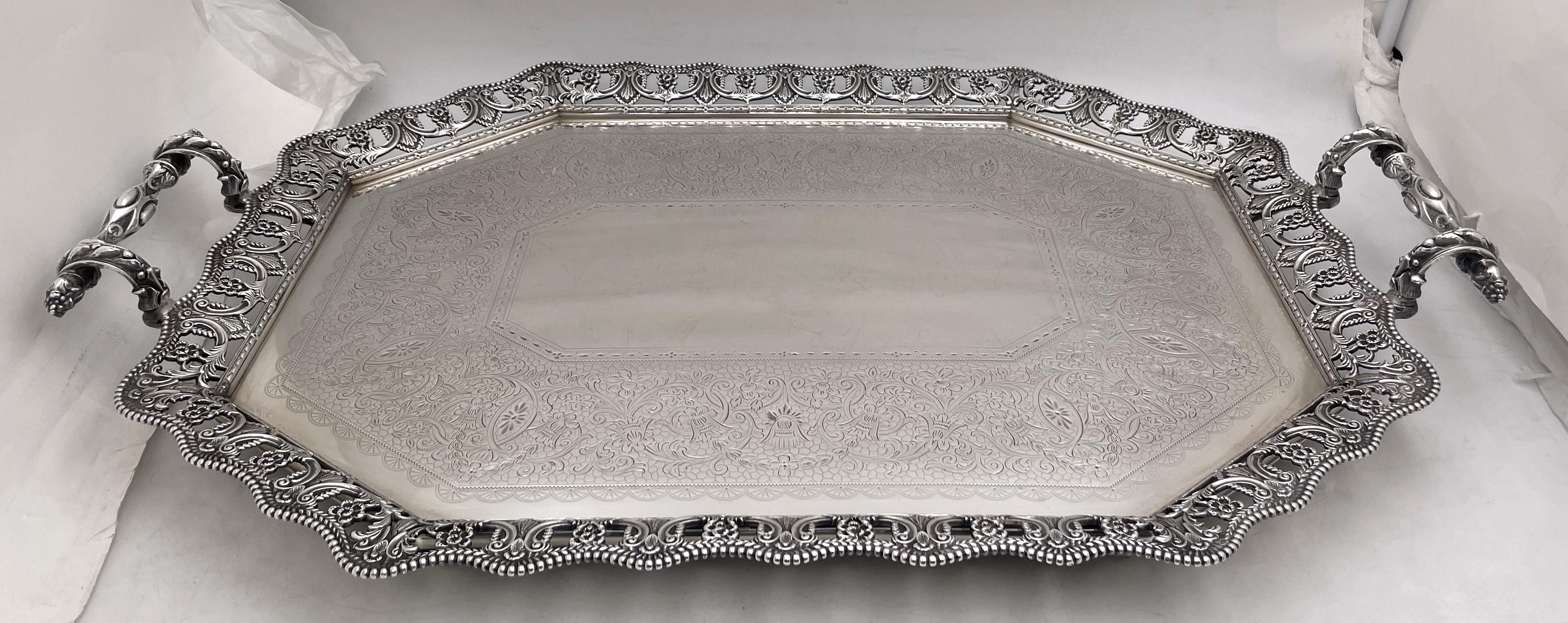 Martin, Hall & Co. sterling silver gallery tray from 1888 (Victorian era), made in Sheffield, England, beautifully adorned with engraved floral and geometric motifs, with two finely applied bamboo style handles, and standing on 4 raised balled feet.