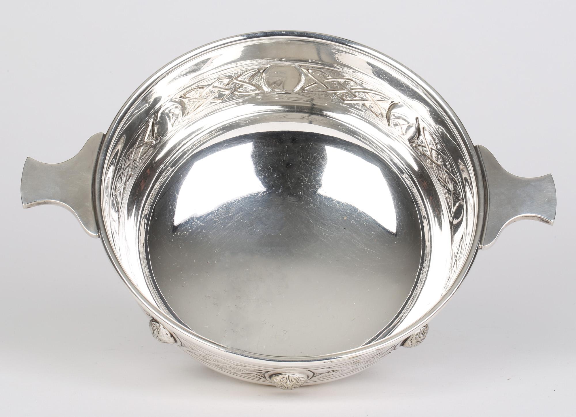 Exceptional quality large Arts & Crafts Sheffield silver plated Celtic revival large twin handled Quaiche bowl by Martin Hall & Co and dating from around 1900. This impressive and heavily made bowl stands raised on four claw styled feet the rounded
