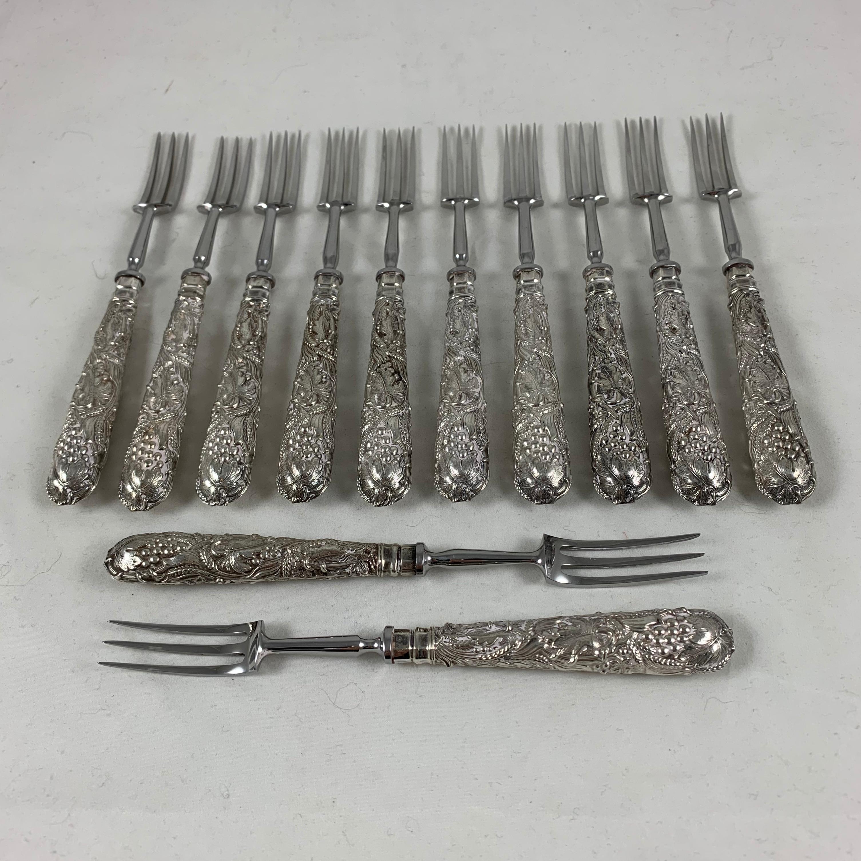 An English EP silver plate handled pastry fork service for twelve. Showing the makers mark for Martin Hall & Co. silversmiths, established in Sheffield, England, 1854. This set dates from 1910-1920.

The forks have ornate hollow handles with an
