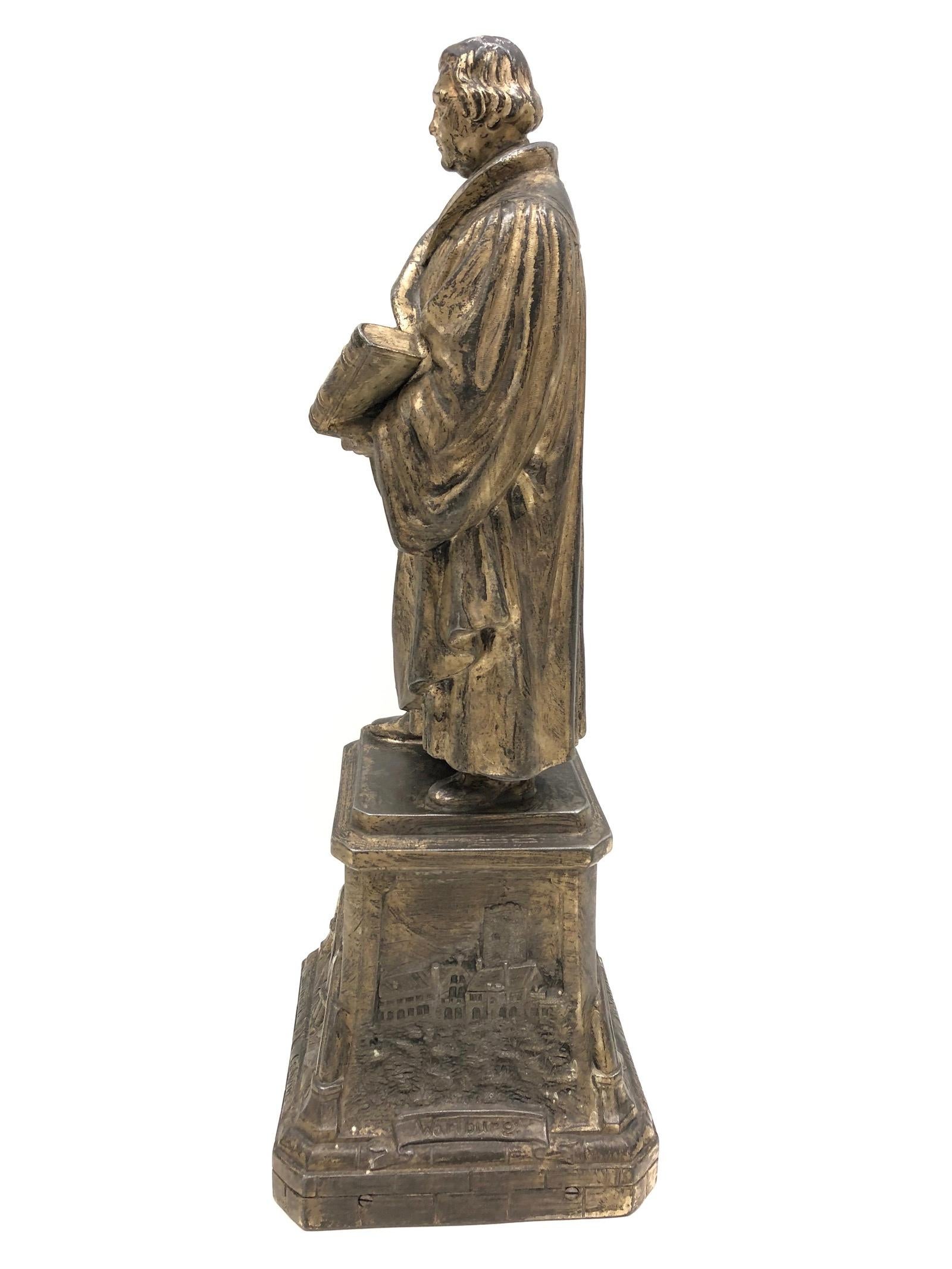 A decorative Martin Luther sculpture or statue. Some wear with a nice patina. Made of metal.