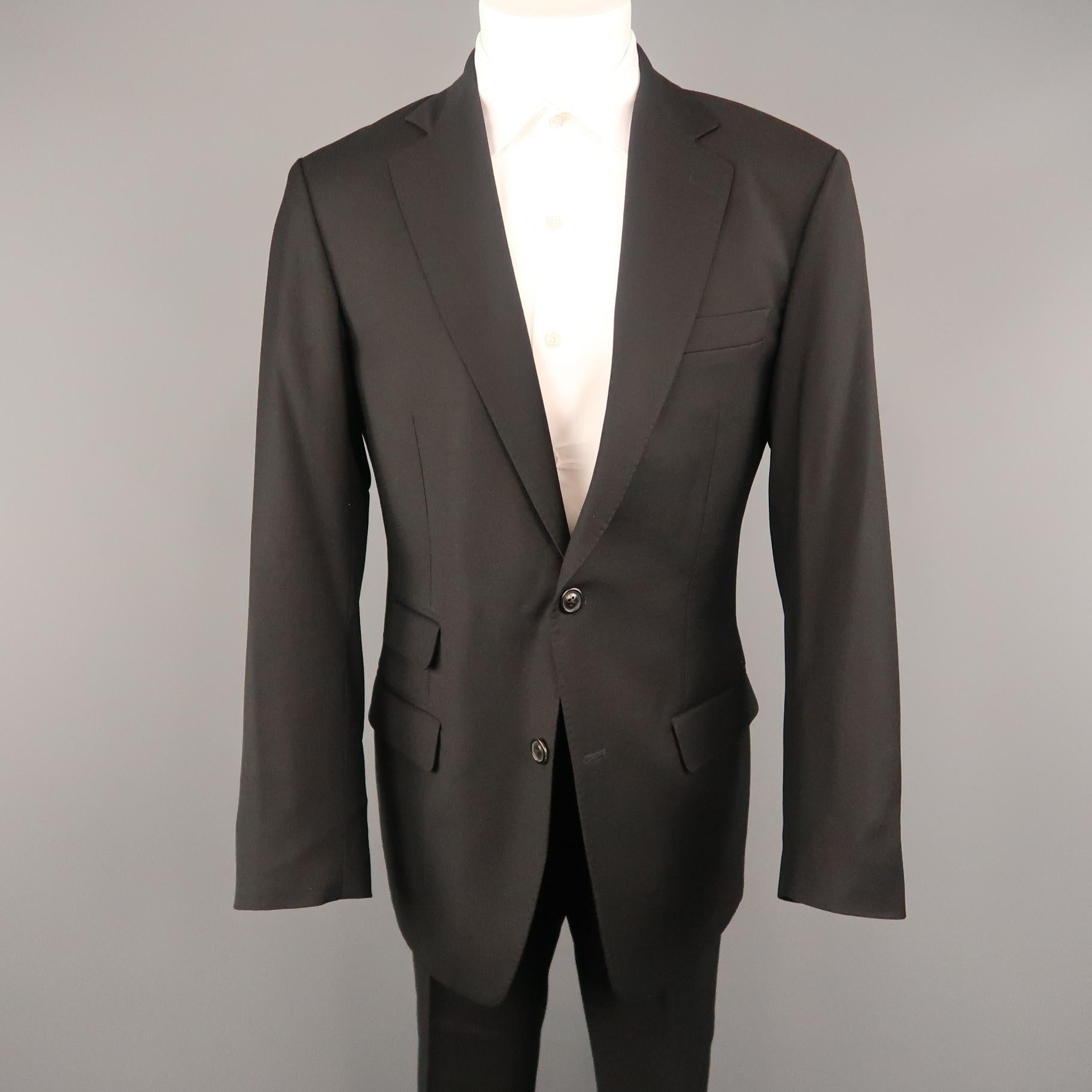 MARTIN MARGIELA REPLICA 80's suit comes in black lana wool twill and includes a single breasted, one button sport coat with notch lapel, functional button cuffs, mock second button detail and matching flat  front trousers. Made in Italy.
 
Excellent