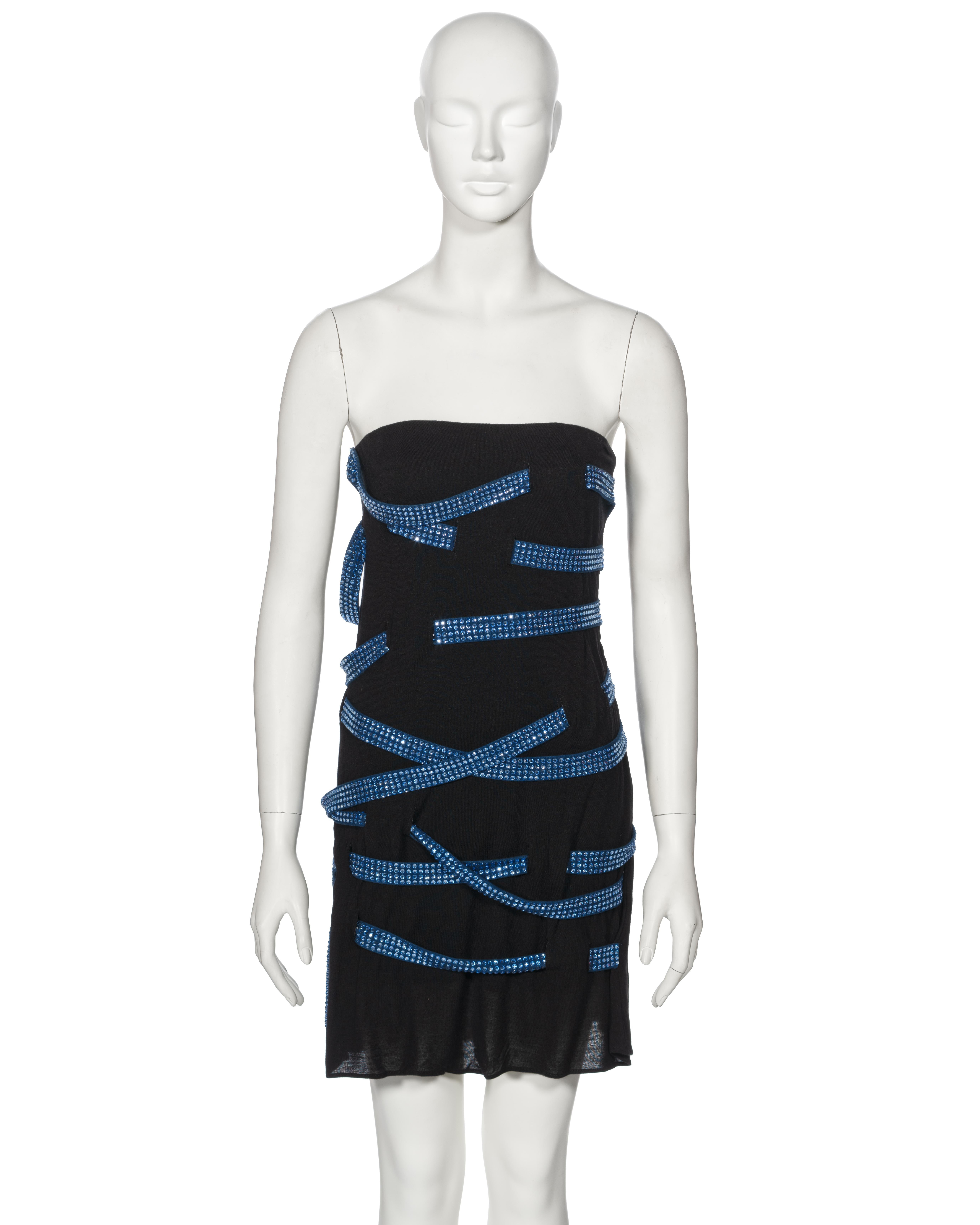 ▪ Archival Margiela Black Crystal-Laced Viscose Mini Dress
▪ Creative Director: Martin Margiela
▪ Spring-Summer 2009
▪ Sold by One of a Kind Archive 
▪ Black viscose jersey construction
▪ Crystal-adorned denim blue lacing, weaving throughout the