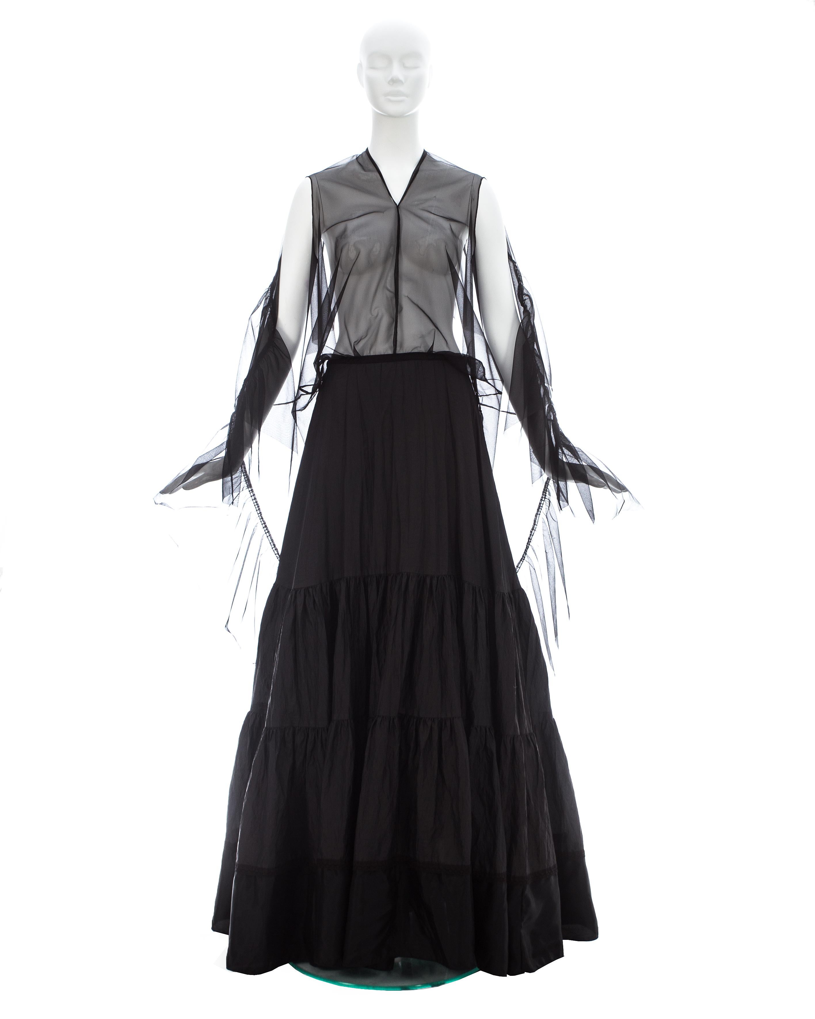 Margiela; Black nylon and polyester maxi dress made with vintage creased petticoats. The top layer of the skirt has a head and arm holes; transforming the skirt into a dress

Spring-Summer 2003