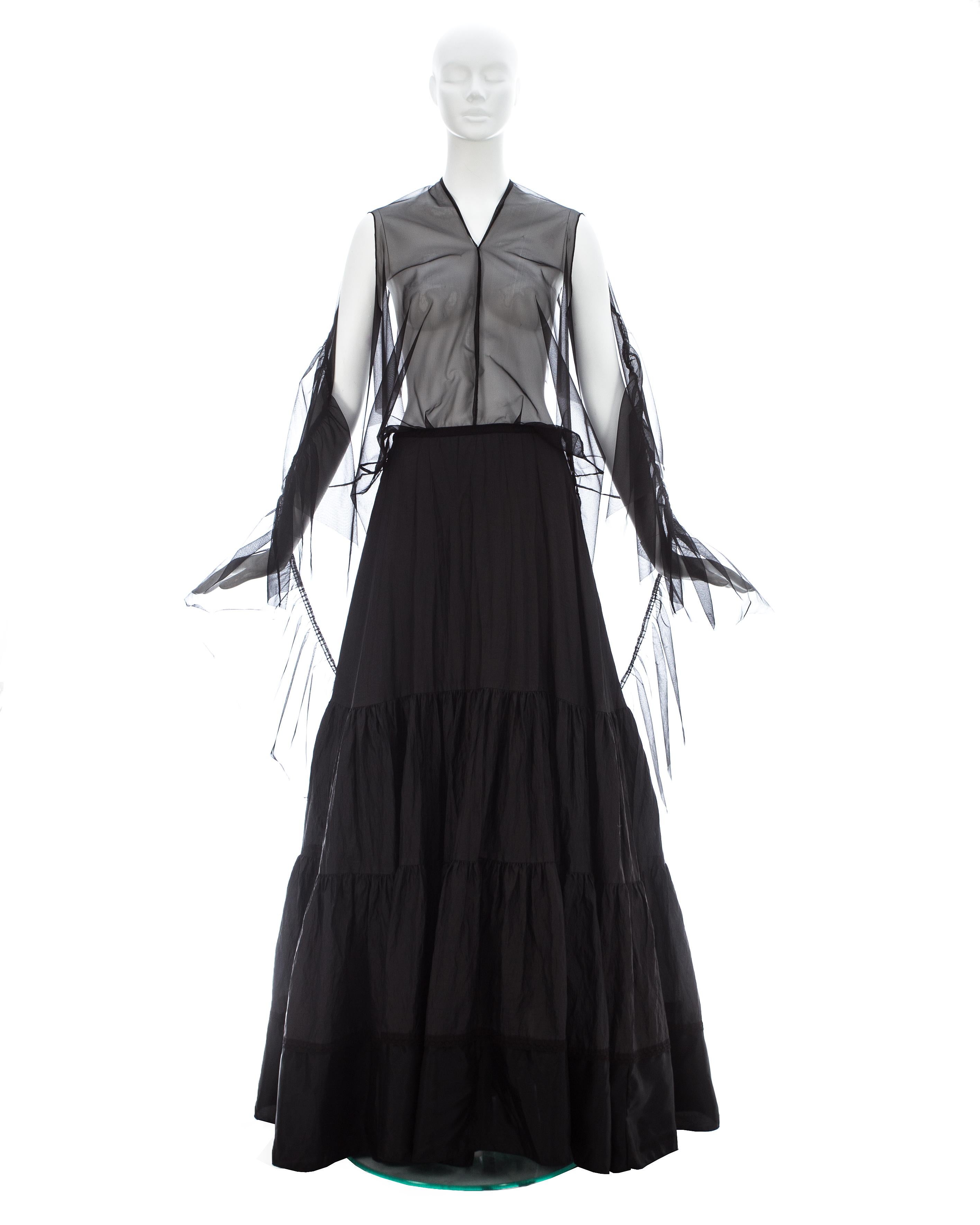 Margiela; Black nylon and polyester maxi dress made with vintage creased petticoats. The top layer of the skirt has a head and arm holes; transforming the skirt into a dress  

Spring-Summer 2003