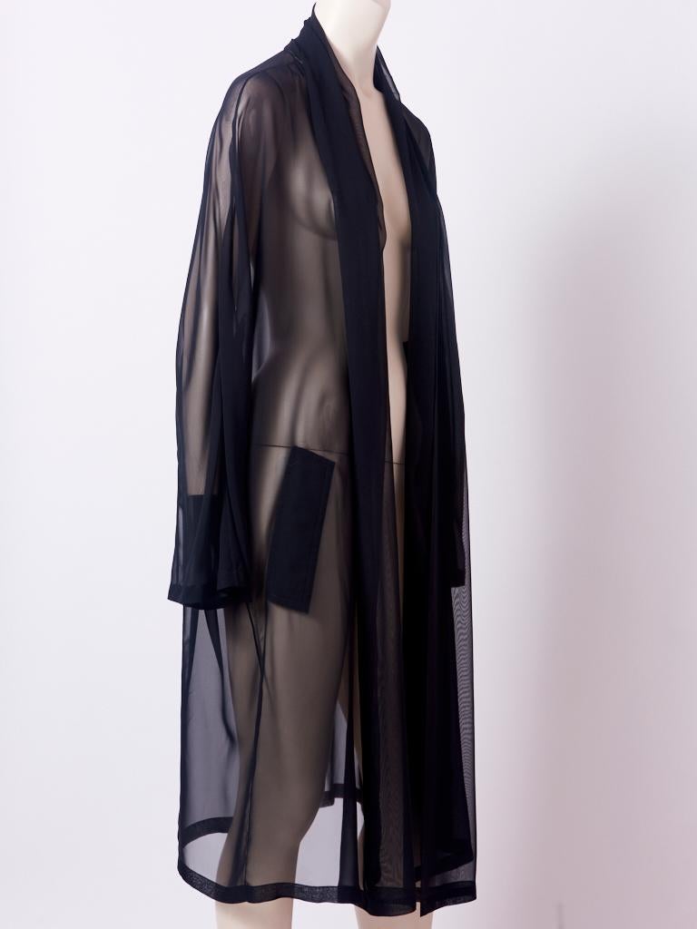 Margiela, for Hermès, black, sheer, chiffon, open, duster coat having no closures from the Fall-Winter 1996-97 collection. This sheer duster was shown over a pantsuit in the collection. There are slits for pockets which were meant to be able to have