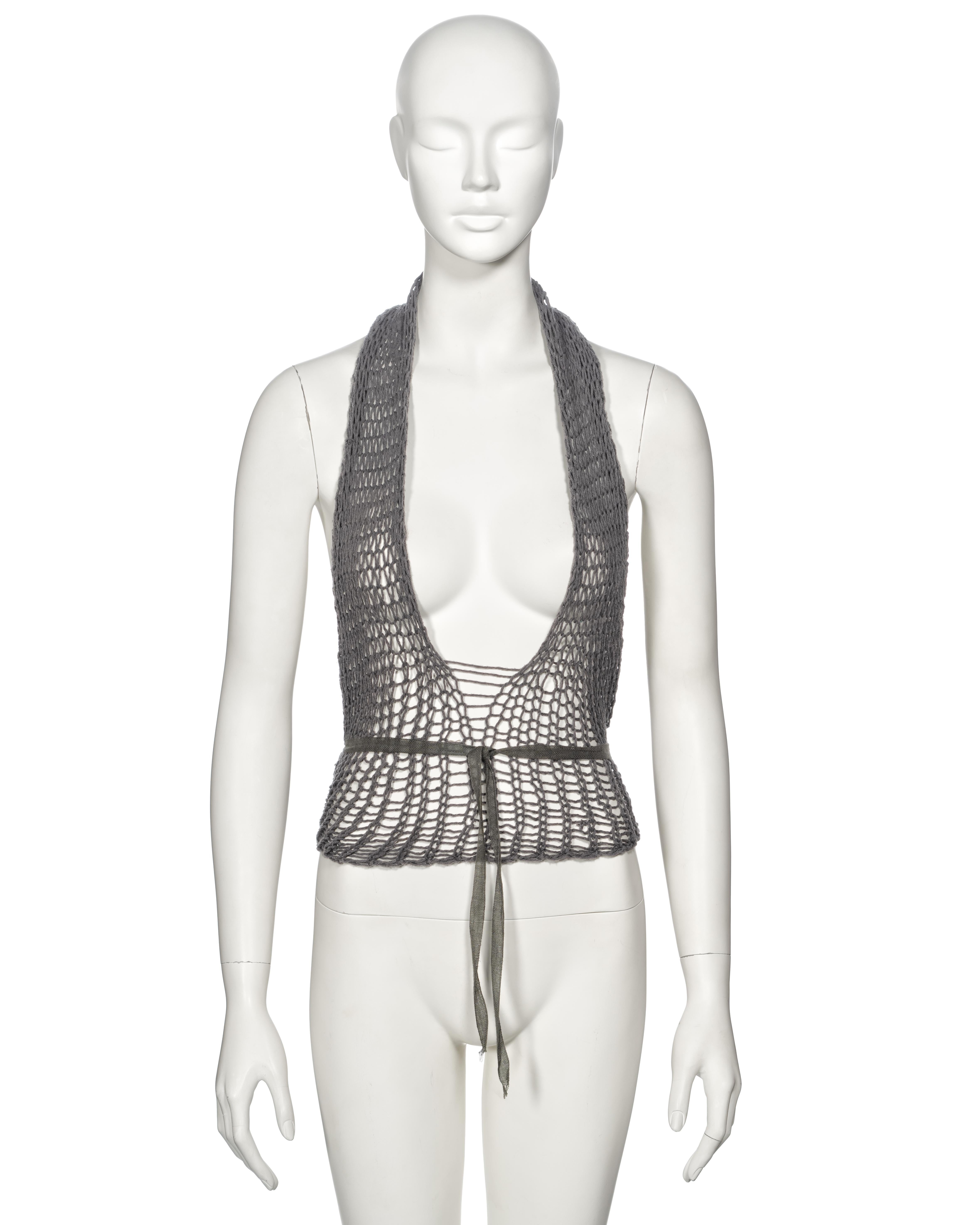 ▪ Archival Margiela Top
▪ Creative Director: Martin Margiela
▪ Spring-Summer 1993
▪ Openwork knit in grey cotton yarn 
▪ Halterneck 
▪ Plunging neckline 
▪ Wrap fastening with cotton ribbon ties 
▪ One Size
▪ Made for the spring-summer 1994