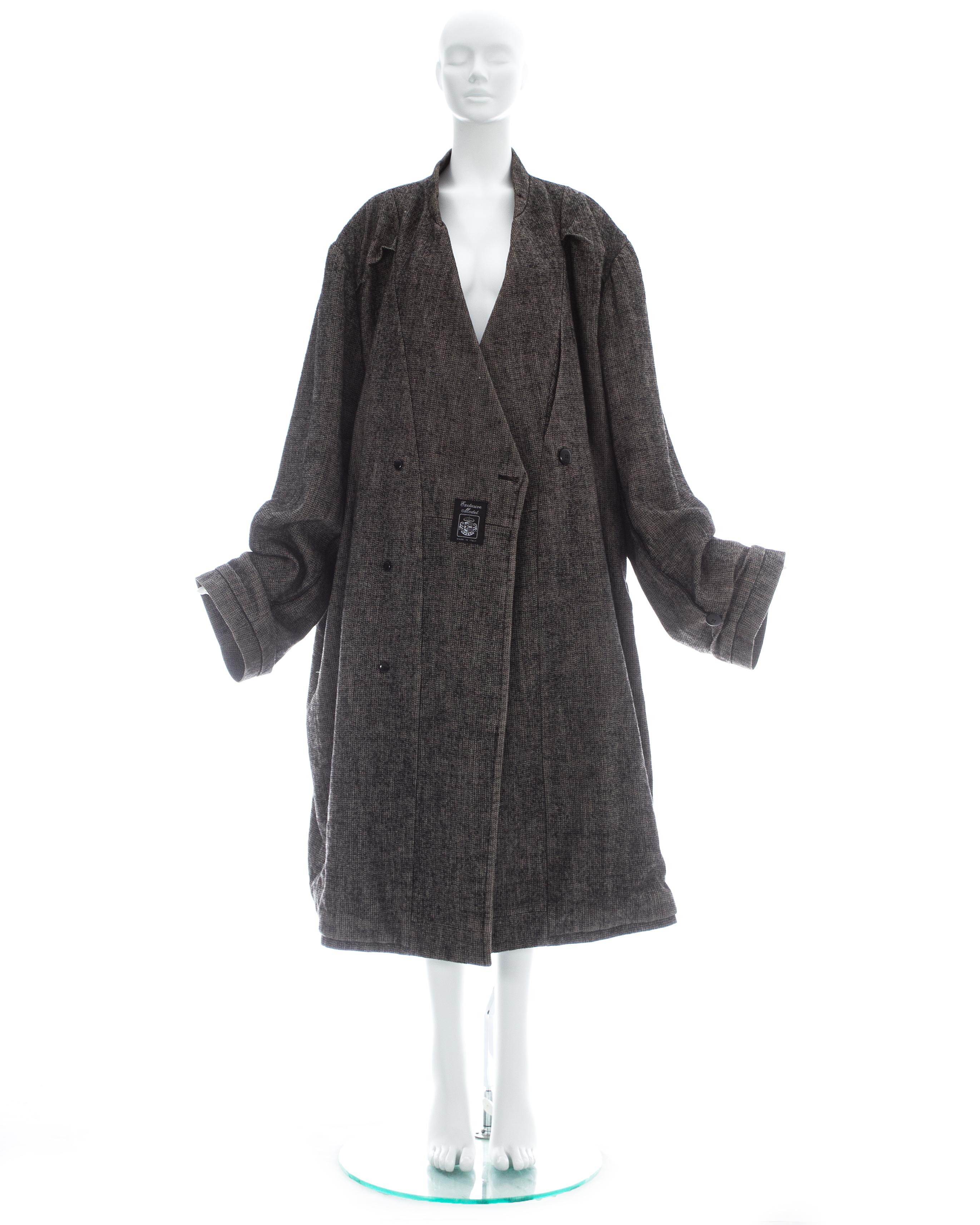 Margiela; Grey wool and linen blend XXL size 78 double inside coat with inverted overlocked seams, permanent creased sleeve cuffs and signature 'Exclusive Model' badge on both sides

Fall-Winter 2000