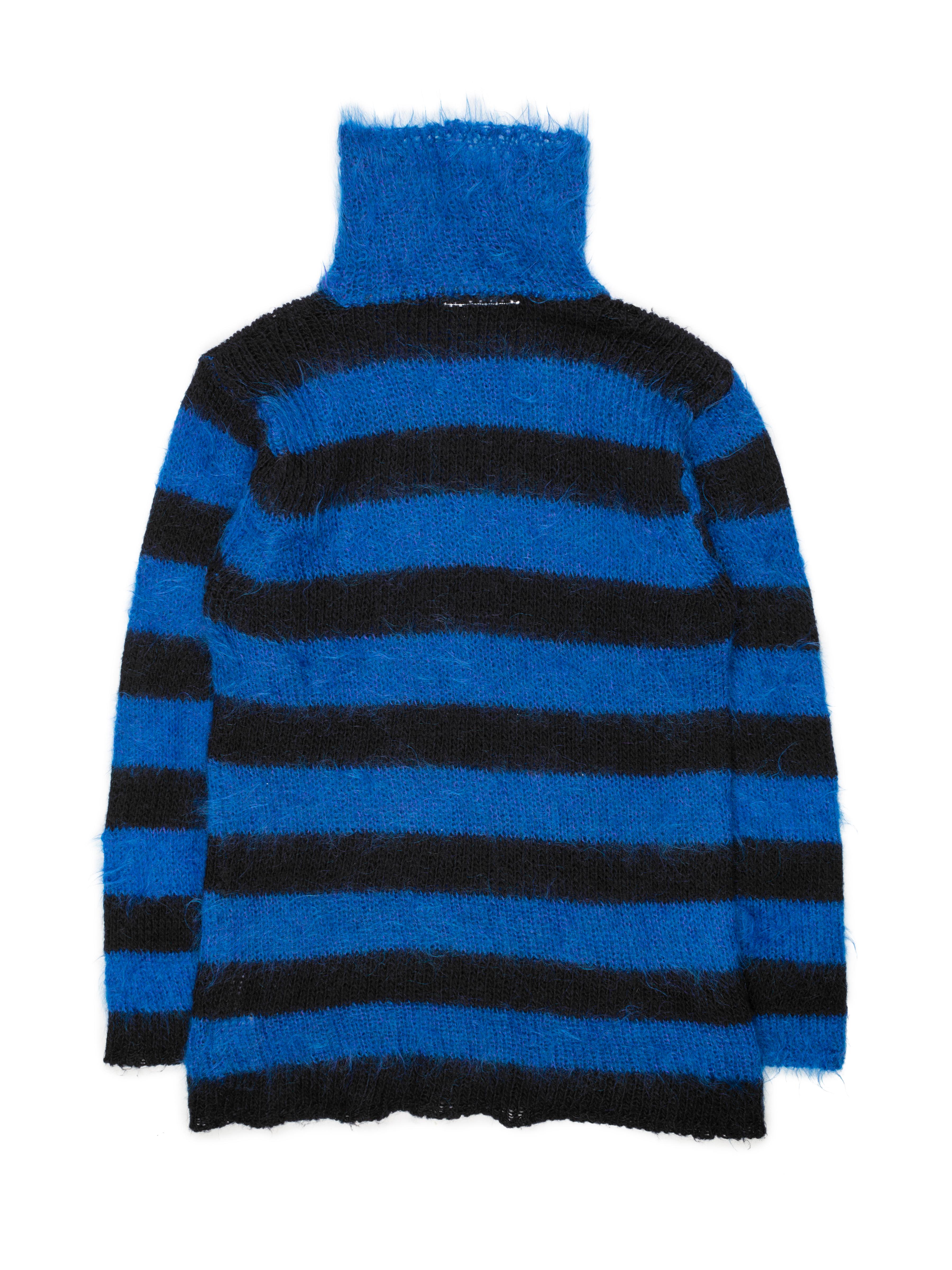 This mohair sweater is cut long and slender, with alternating stripes of blue and black. It comes from the “Miss Deanna” era of Margiela — a nom de plume for Deanna Ferretti Veroni, a knitwear artisan employed by numerous major European fashion