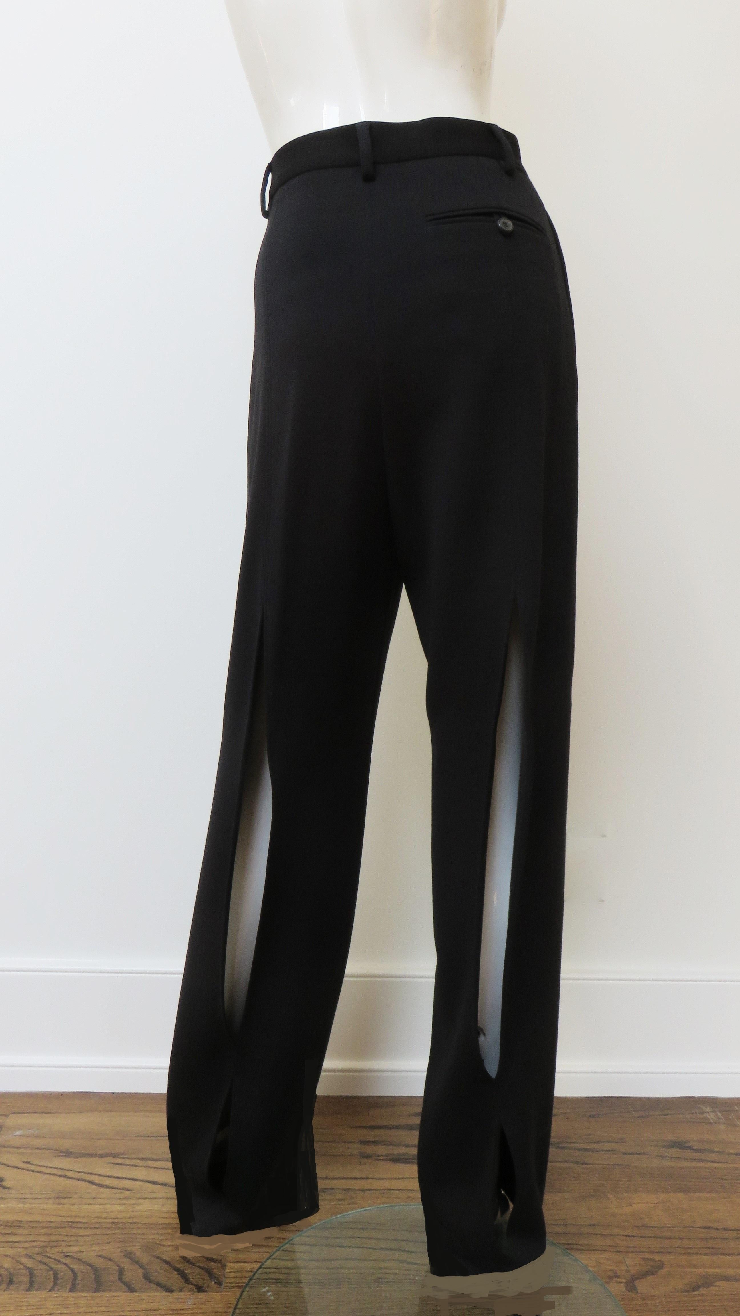 Beautiful wool pants from Martin Margiela. They are high waisted with a button waistband, fly front and full legs with 2 vertical splits one larger with a smaller one below it along the center back of each leg.  They have a back welt pocket with a