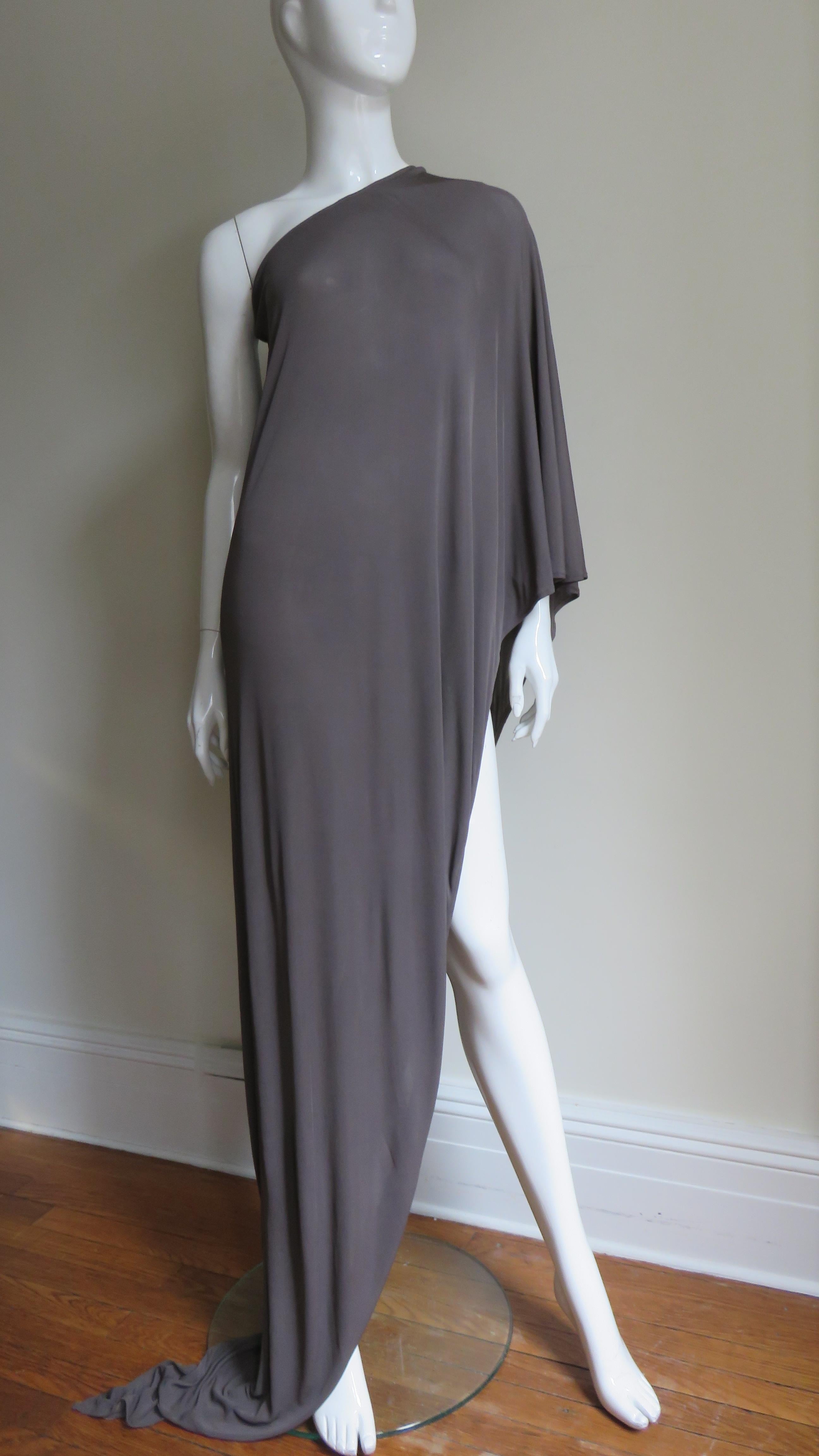 A taupe jersey half poncho from an early collection of Belgium designer Martin Margiela. It exposes one shoulder and crosses at an angle to a point at the opposite side hem. Slips on over the head. 
One size fits all

Length 62