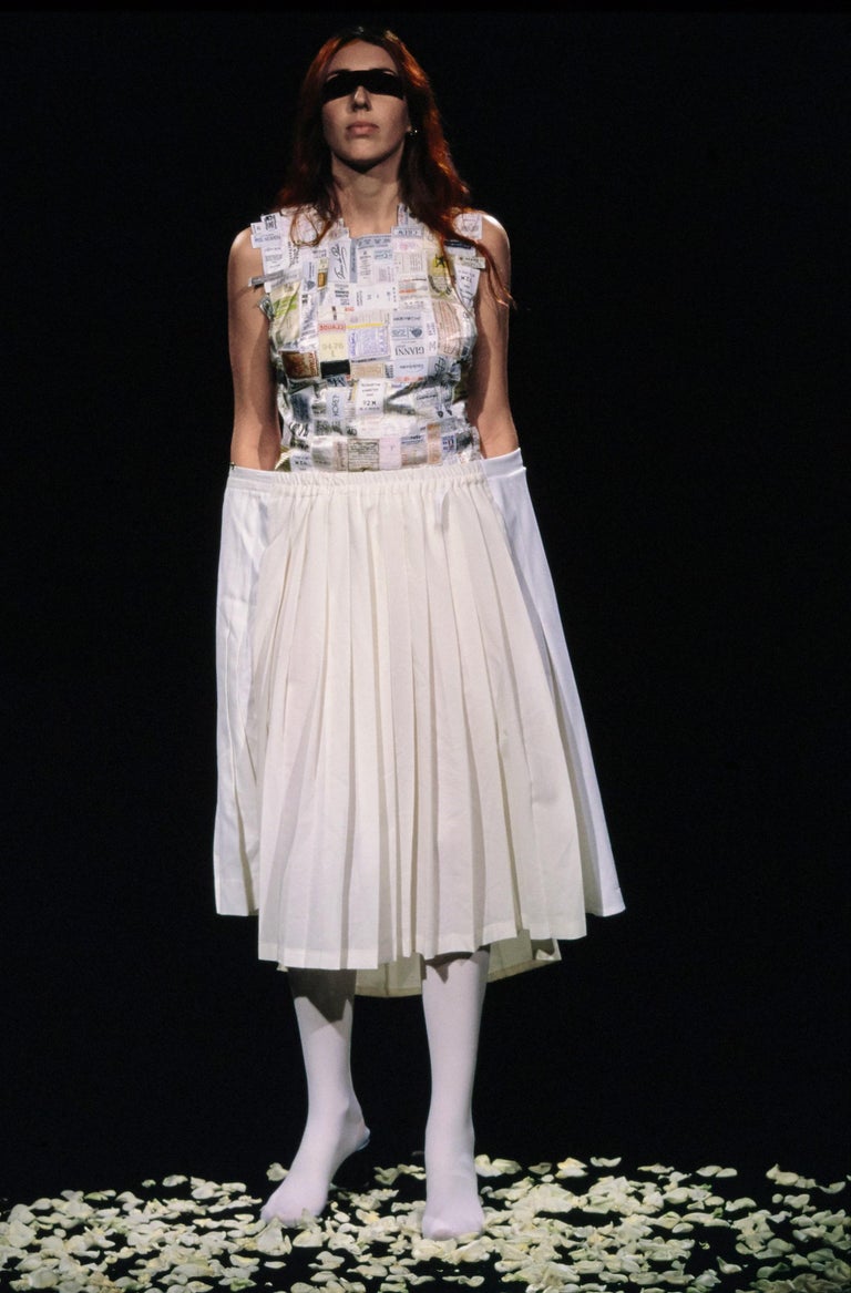 Martin Margiela shirtfront made up of reclaimed vintage labels in composite materials in shades of white or light colours. 

Spring-Summer 2001