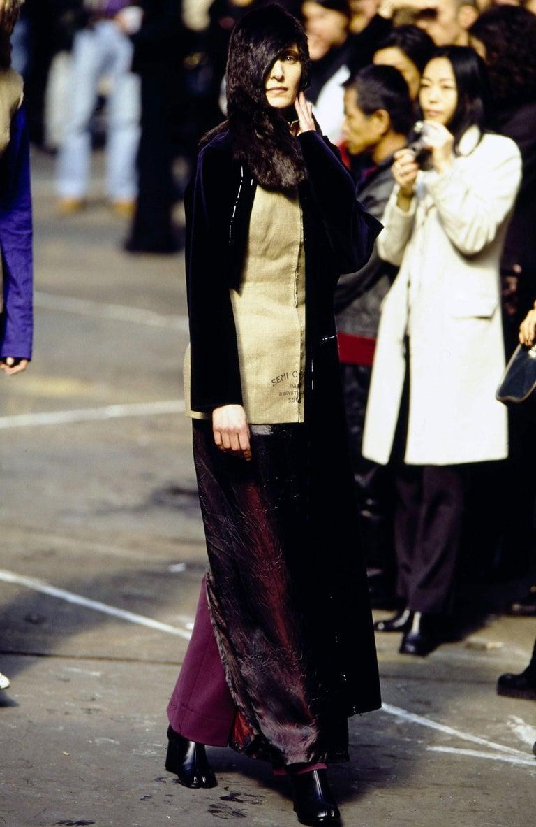 Martin Margiela runway ensemble comprising: Stockman corset, cream velvet 'basting' jacket, red acetate slip dress, brown leather knee high wedge Tabi boots, and red fur wig (made by BLESS).

Fall-Winter 1997