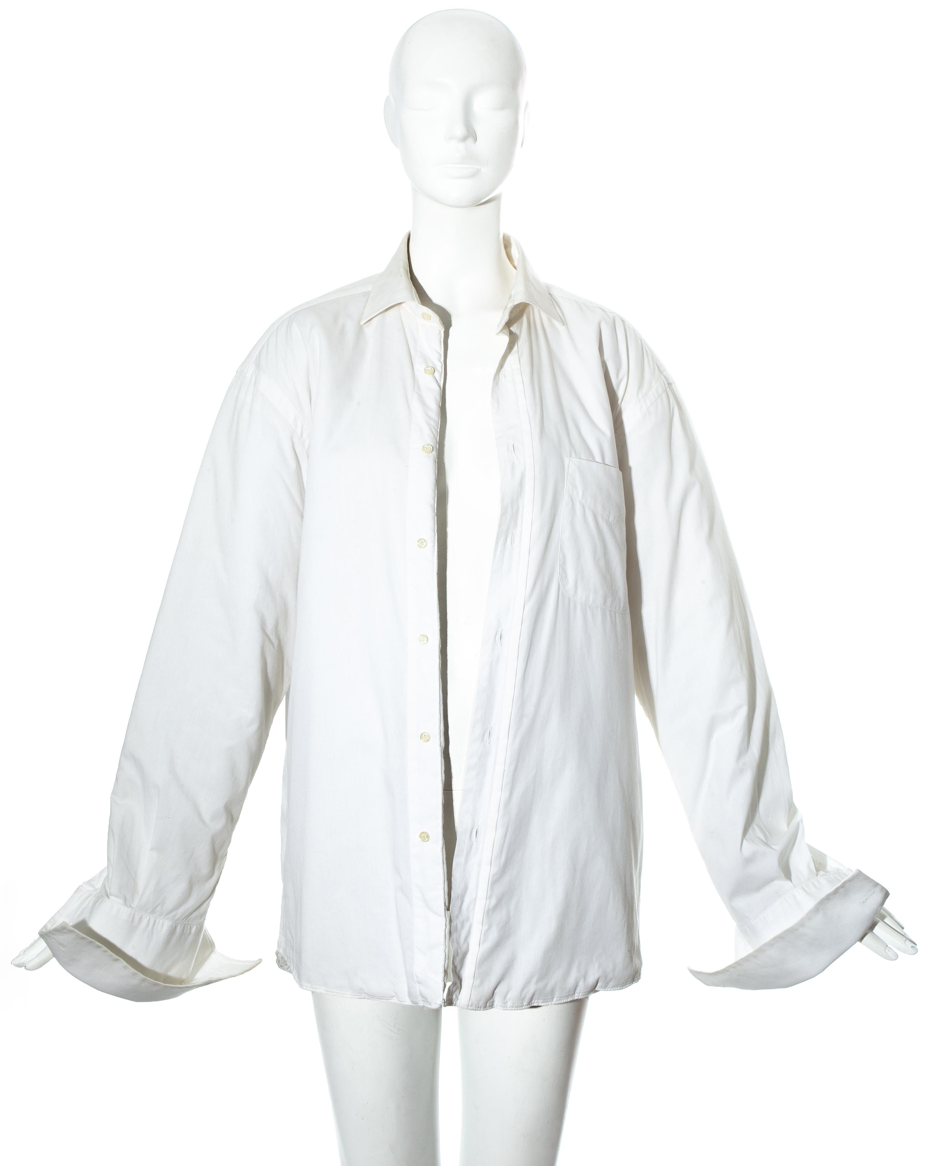 Martin Margiela white cotton oversized shirt jacket with large turn-over cuffs and quilted lining. 

Margiela reconstructed vintage white shirts by adding a quilted lining which resulted in a classic white shirt being worn as outerwear.