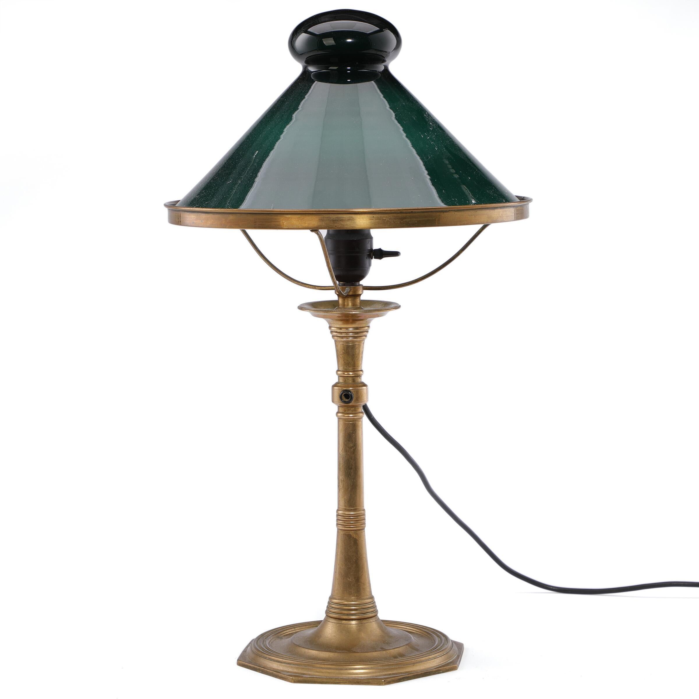 Martin Nyrop Brass table lamp. Shade of green opal glass. Performed approx. the beginning of the 20th century H. 55. Designed for Copenhagen City Hall.

Martin Nyrop (11 November 1849 on Holmsland by Ringkøbing Fjord – 18 May 1921 in