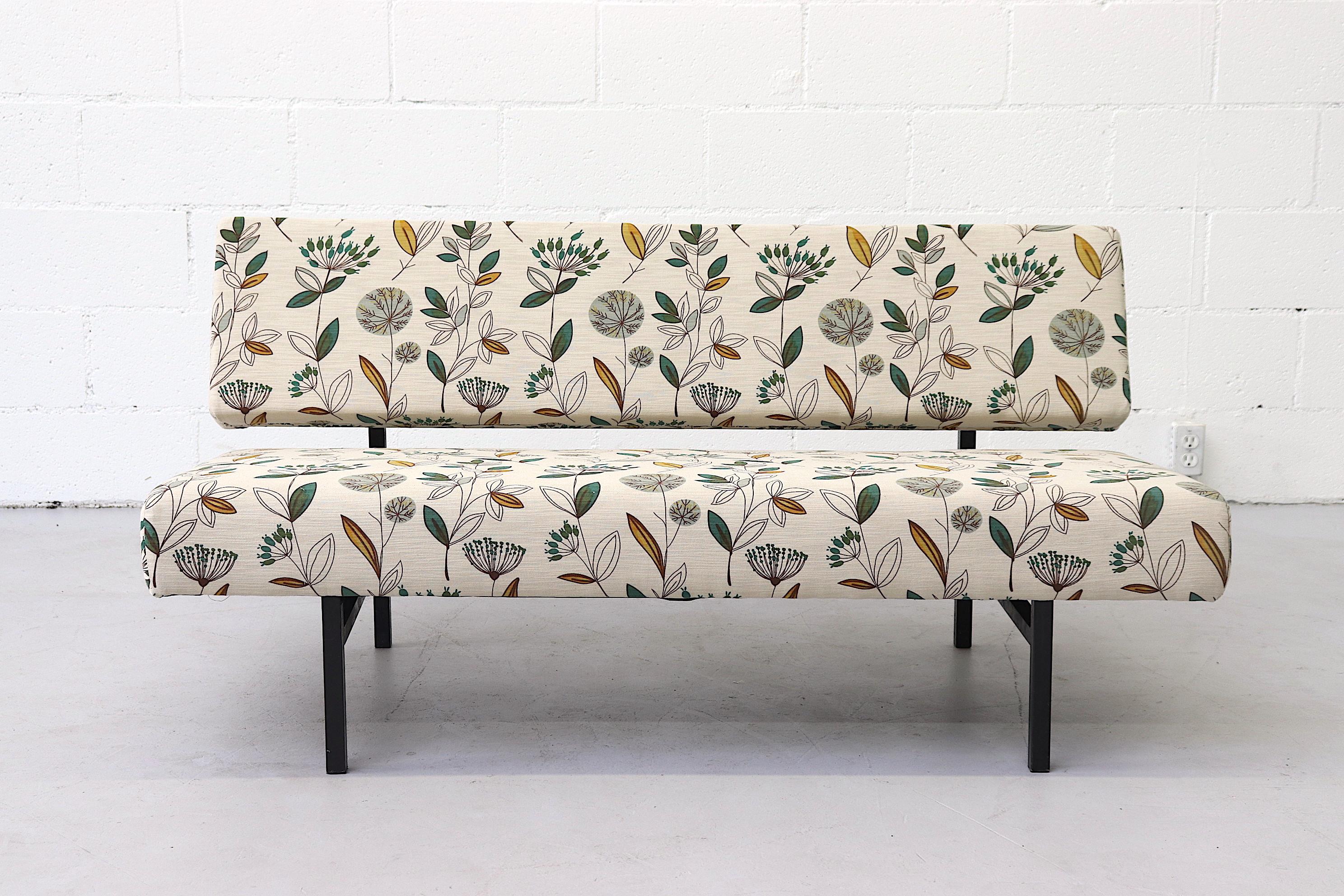 Sweet 2-seat midcentury streamline sofa with new leafy print upholstery and black enameled metal frame. In original condition with some visible wear. Other similar sofas available and listed separately. (LU92244227923, LU922413353701,