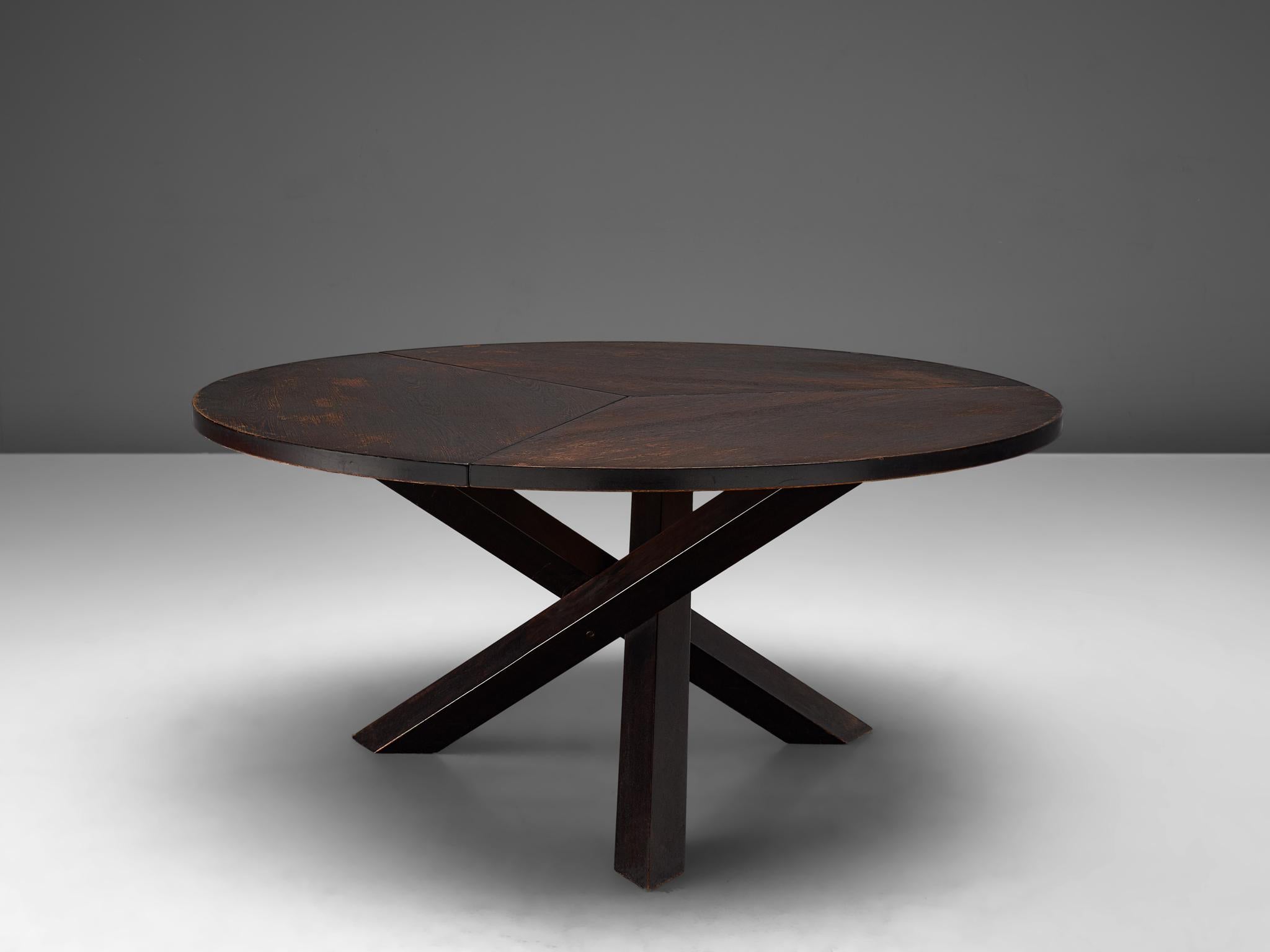 Martin Visser for 't Spectrum, dining table, in darkened wengé and wood, the Netherlands, 1960s.

Beautiful wengé dining table with round top, divided into three parts. The base consist of three crossed legs of solid, darkened wood. The veneer top