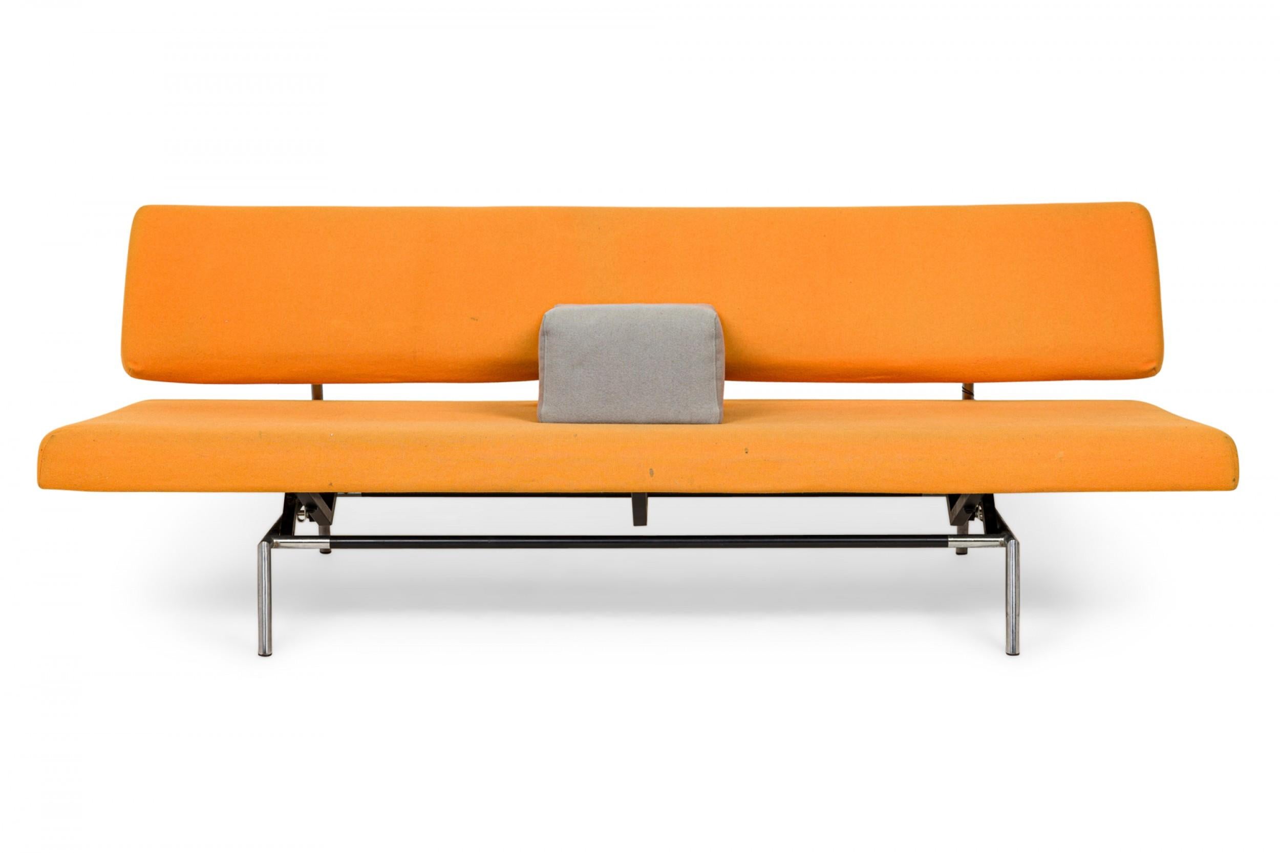 Mid-Century Modern sleeper sofa with orange felt upholstered seat and back supported by a silver metal frame with a shifting mechanism that allows the sofa to convert to a daybed, with a square blue upholstered movable pillow/armrest. (MARTIN VISSER