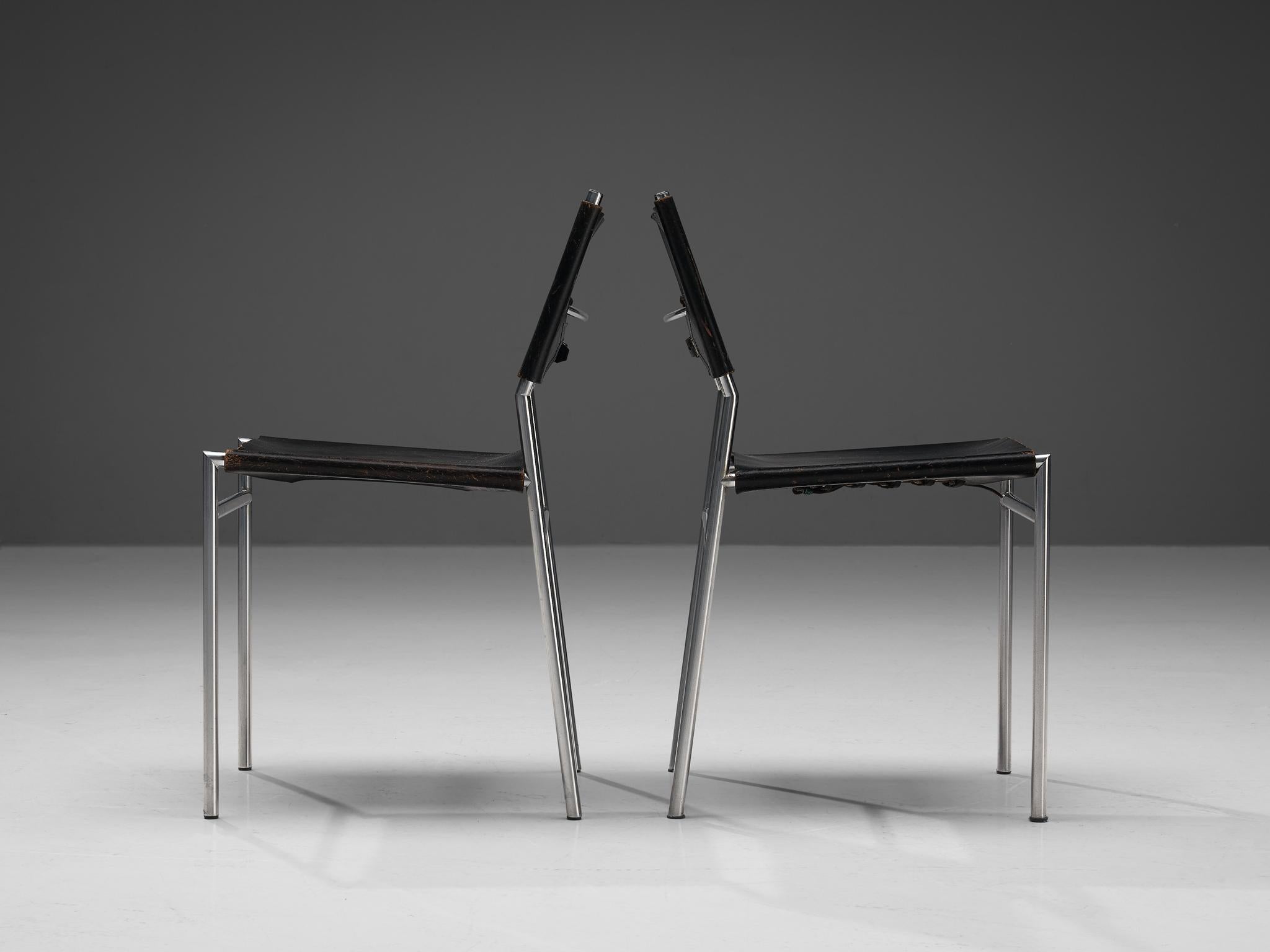 Martin Visser for 't Spectrum, pair of dining room chairs, steel, patinated leather, The Netherlands, 1960s. 

The designs of Martin Visser are characterized by clear lines and the use of metal in combination with natural materials like leather or