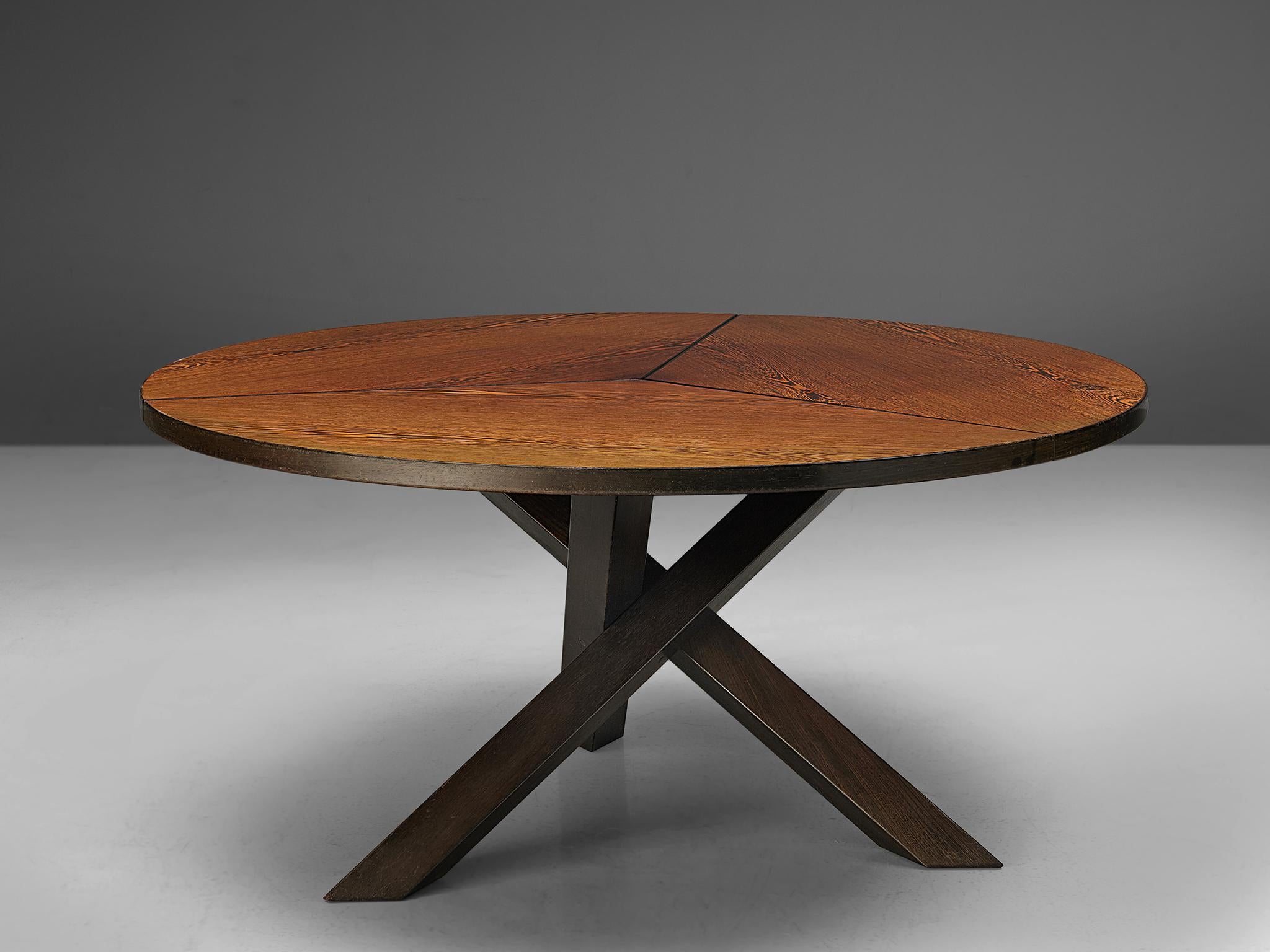 Martin Visser for 't Spectrum, dining table, wengé and wood, the Netherlands, 1960s.

Beautiful wengé dining table with round top, divided into three parts. The base consist of three crossed legs of solid, darkened wood. The veneer top shows an